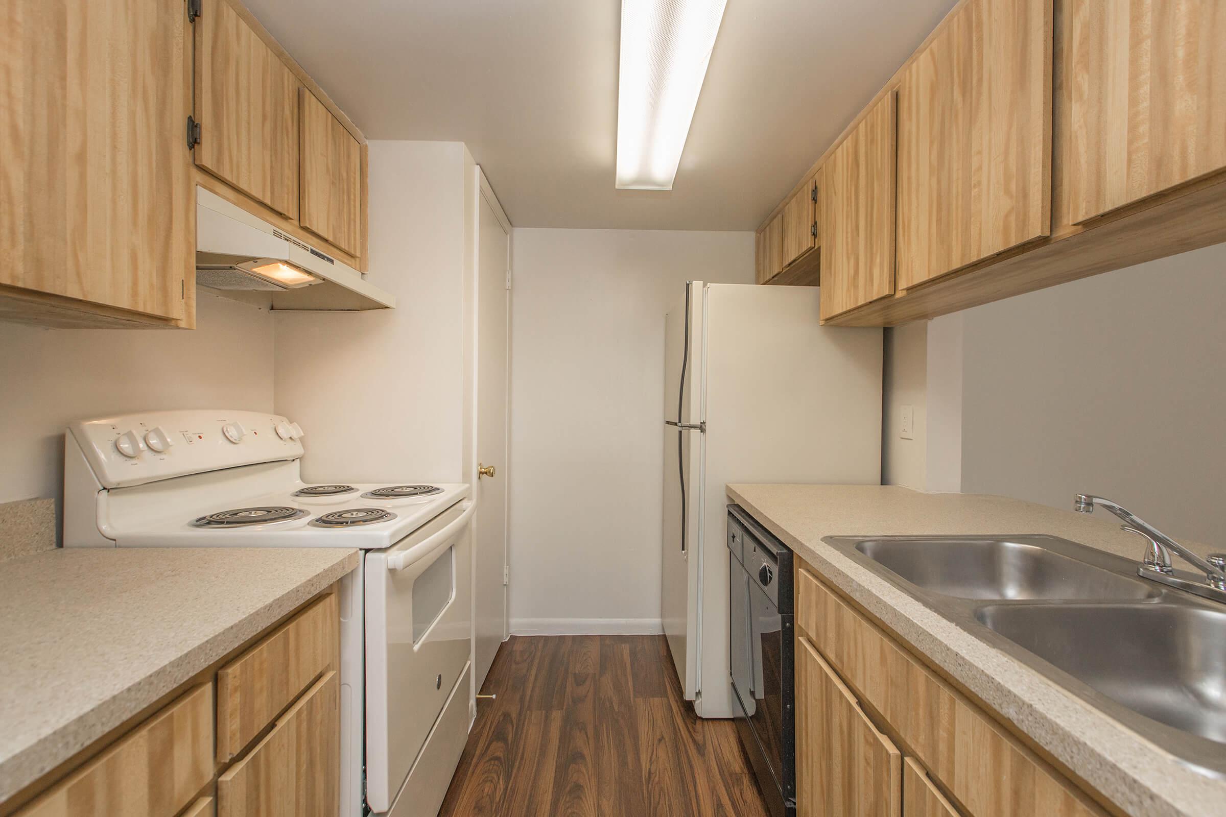 a kitchen with stainless steel appliances and wooden cabinets