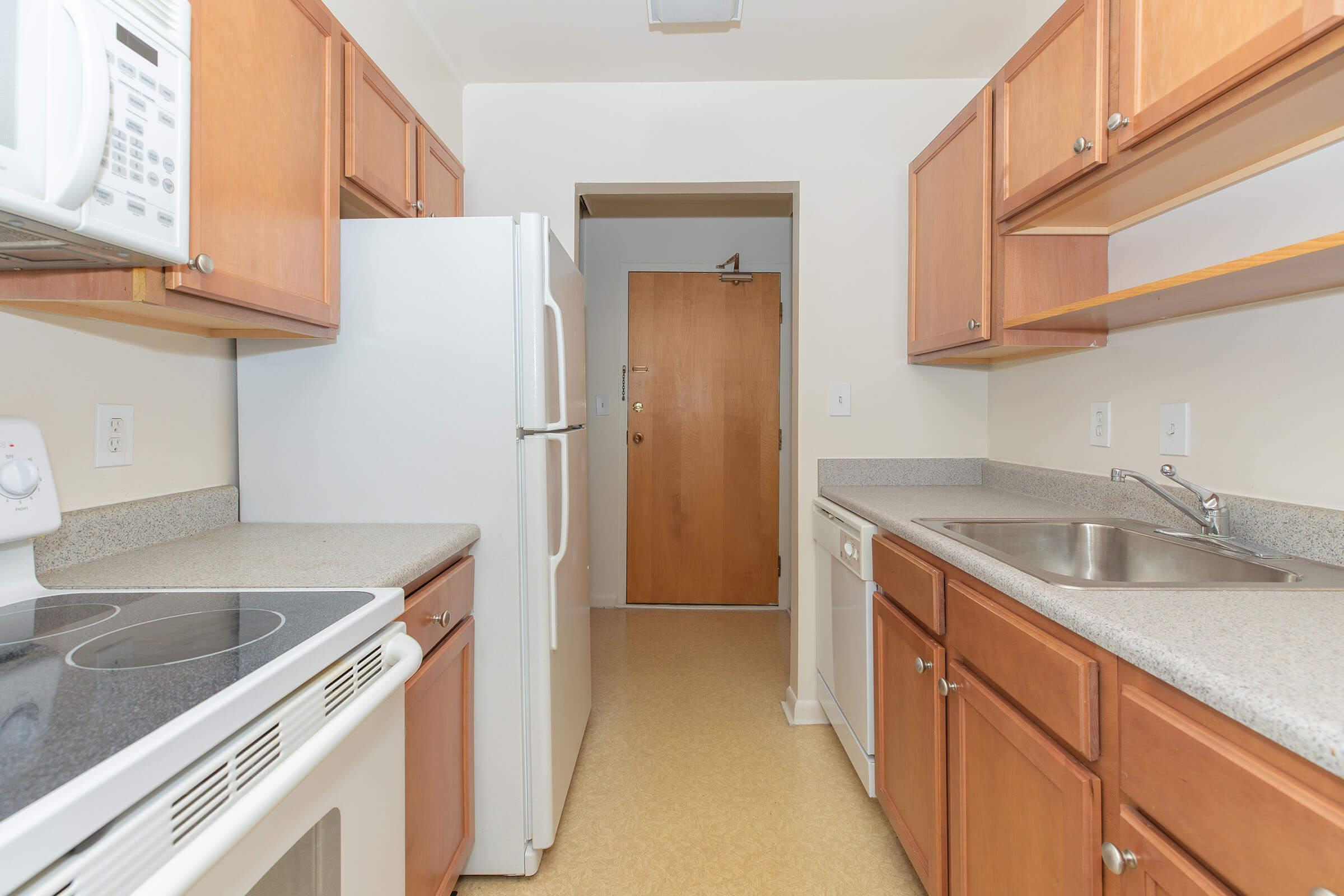 a kitchen with a sink and a refrigerator