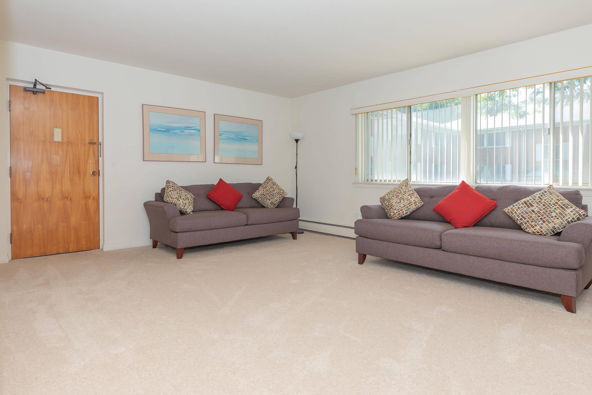 a living room filled with furniture and a flat screen tv