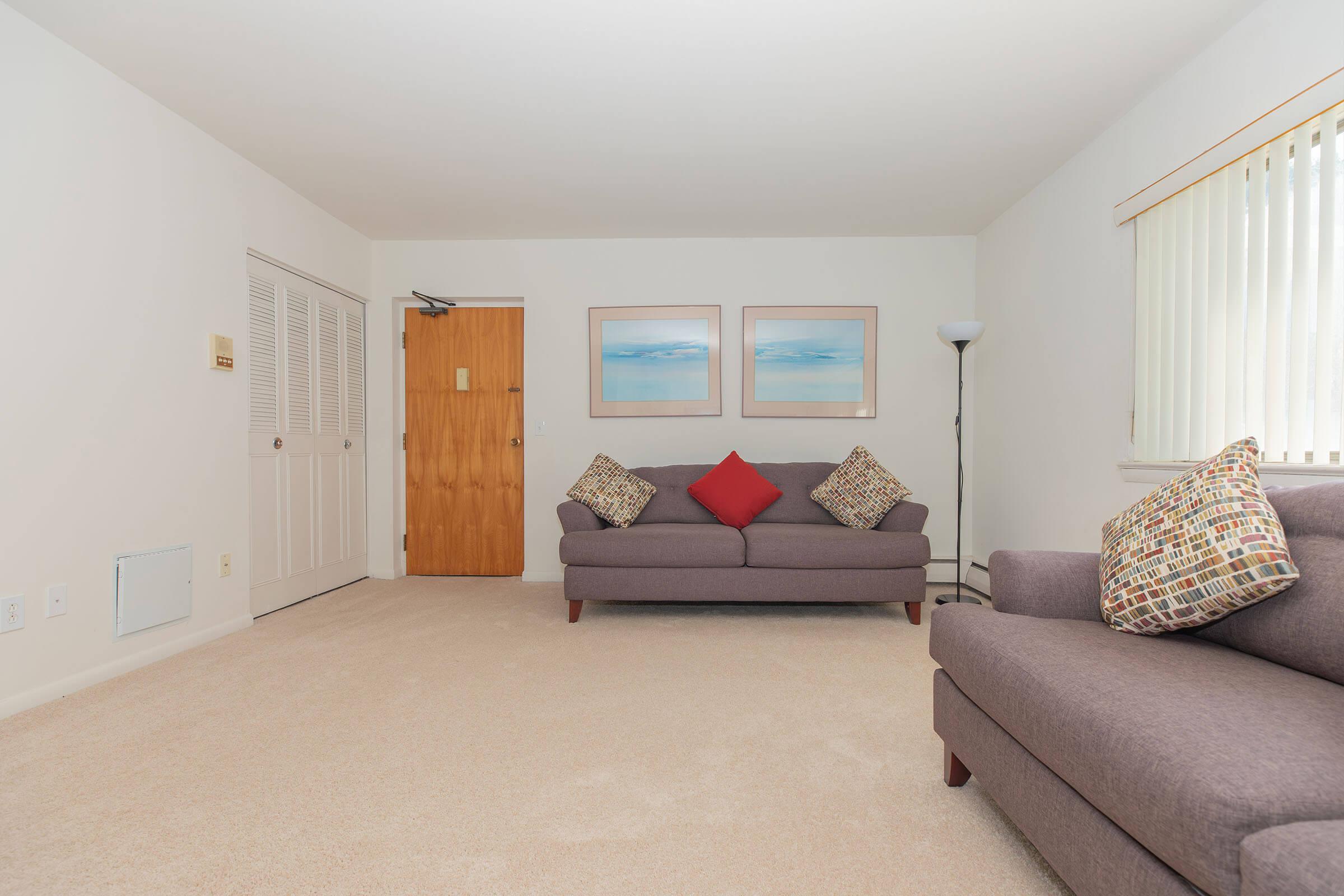 a bedroom with a view of a living room