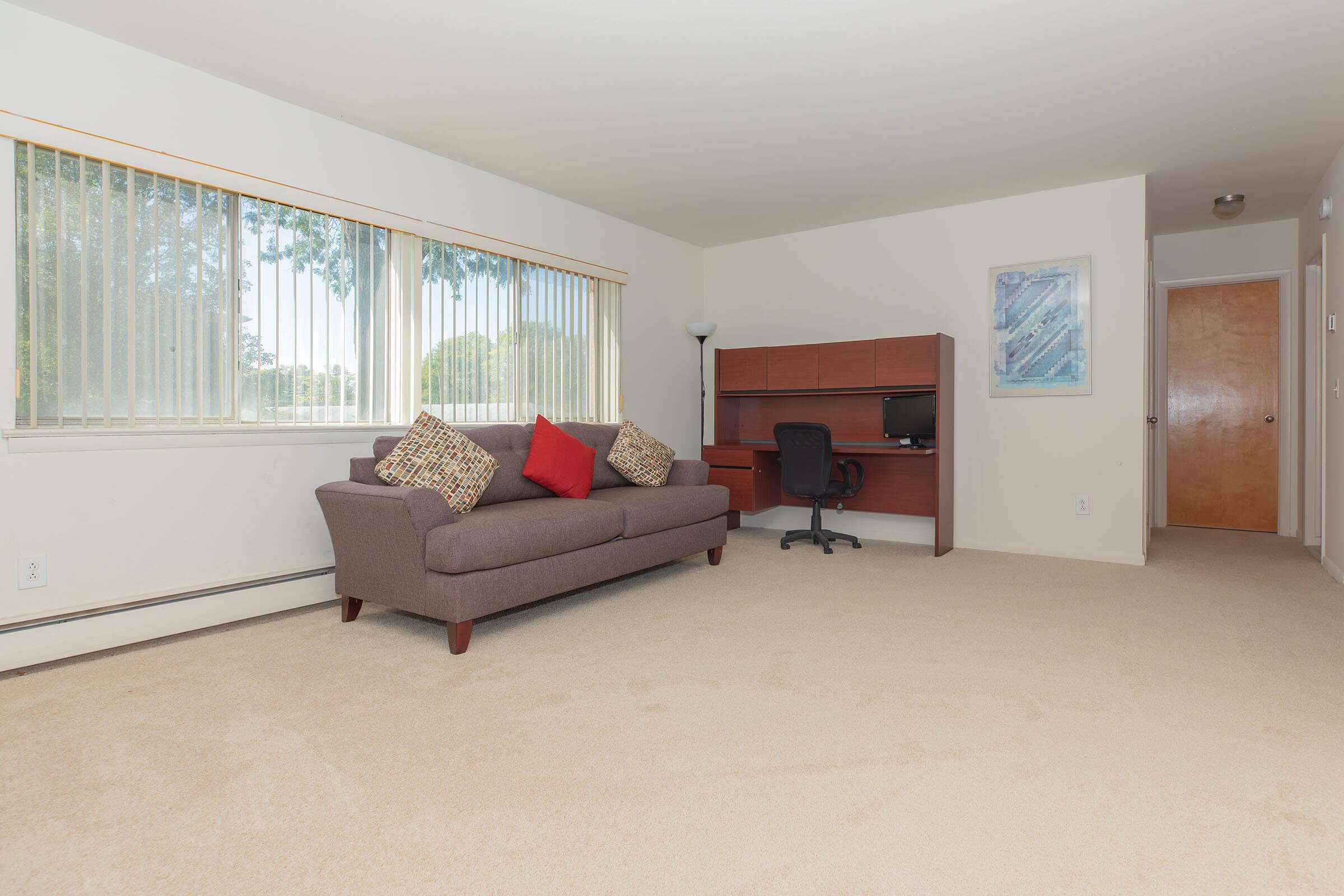 a living room filled with furniture and a flat screen tv