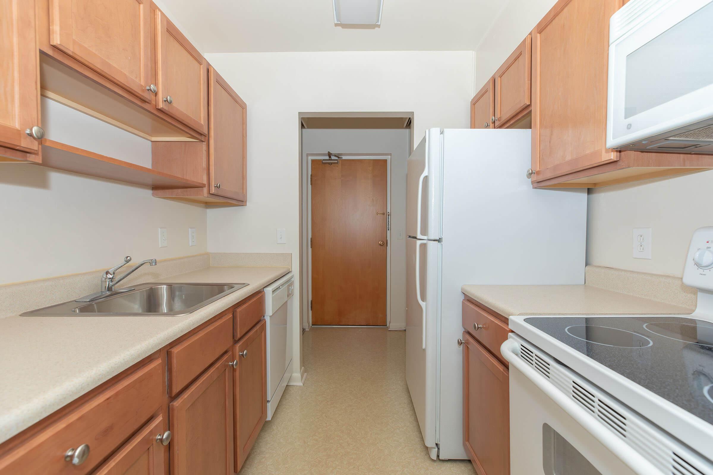 a kitchen with a sink and a refrigerator