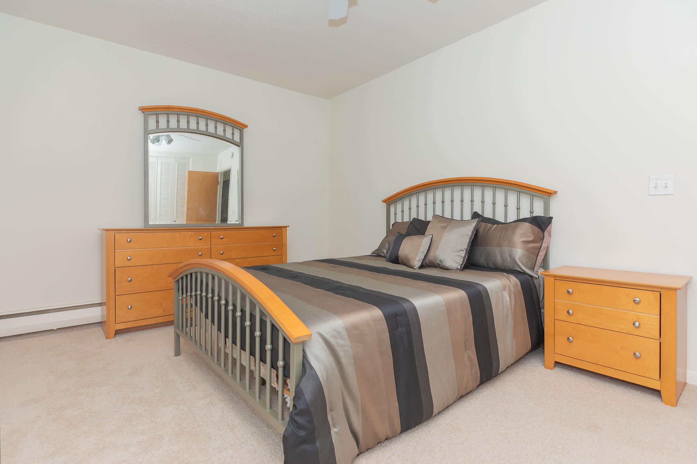 a bedroom with a bed and desk in a small room