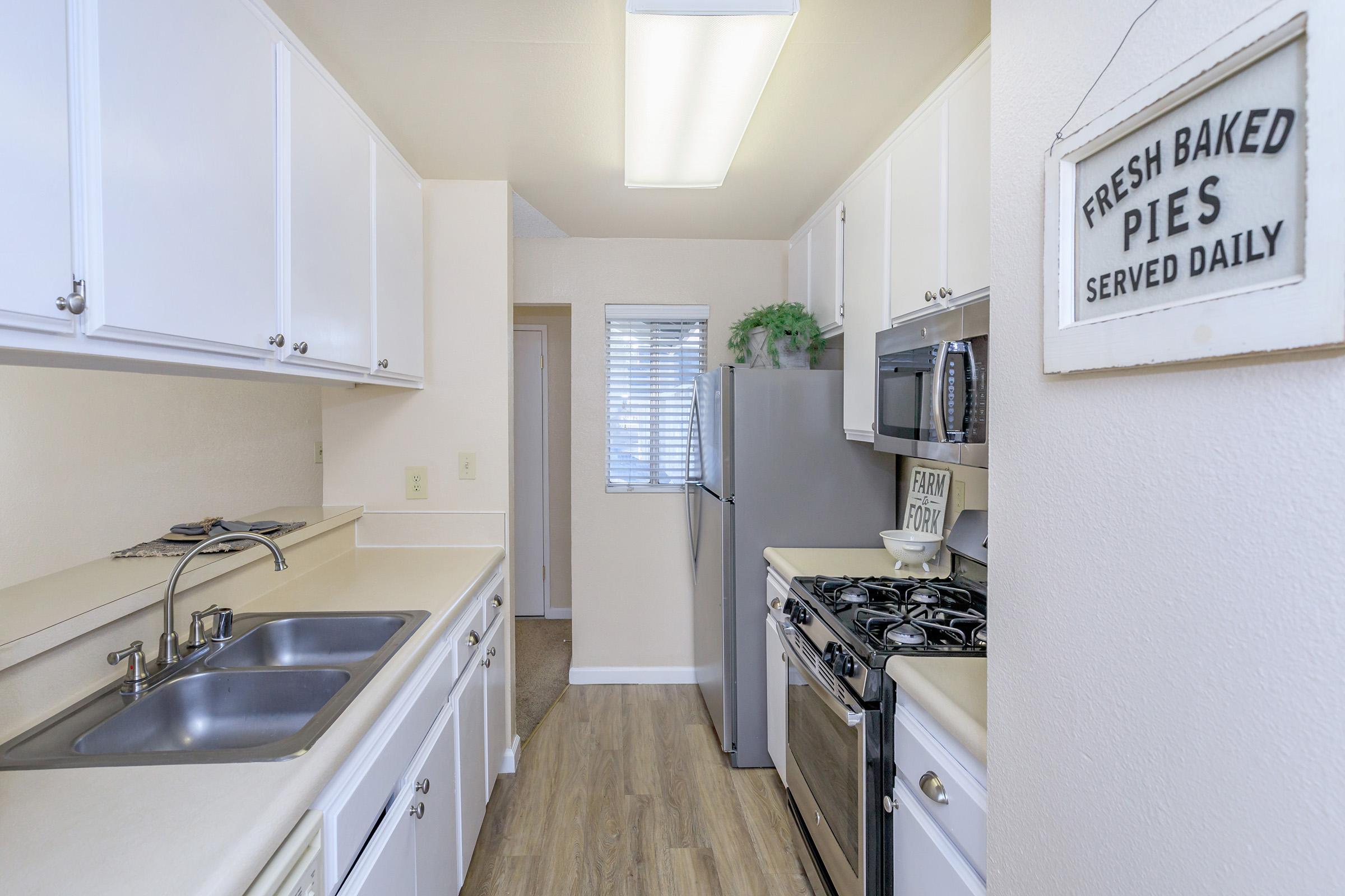 a kitchen with a sink and a window