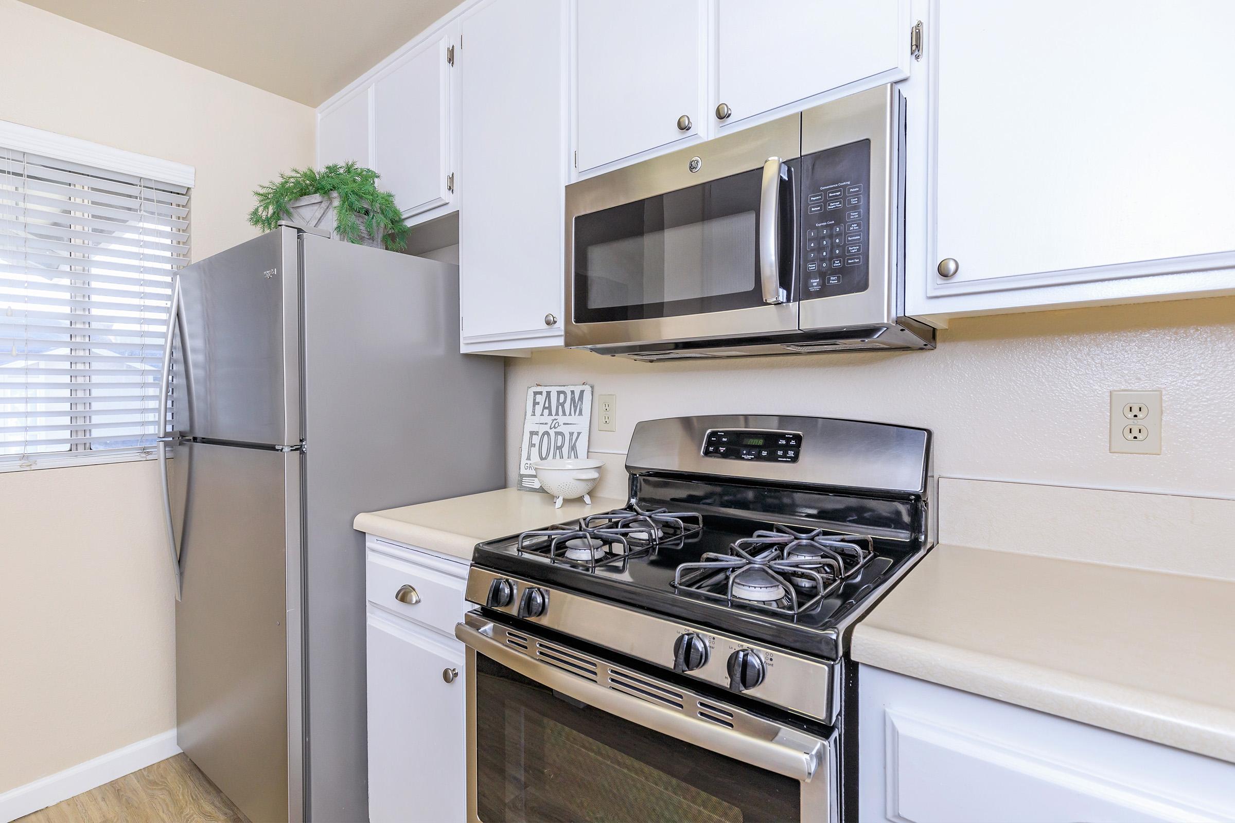 a stove top oven sitting inside of a kitchen