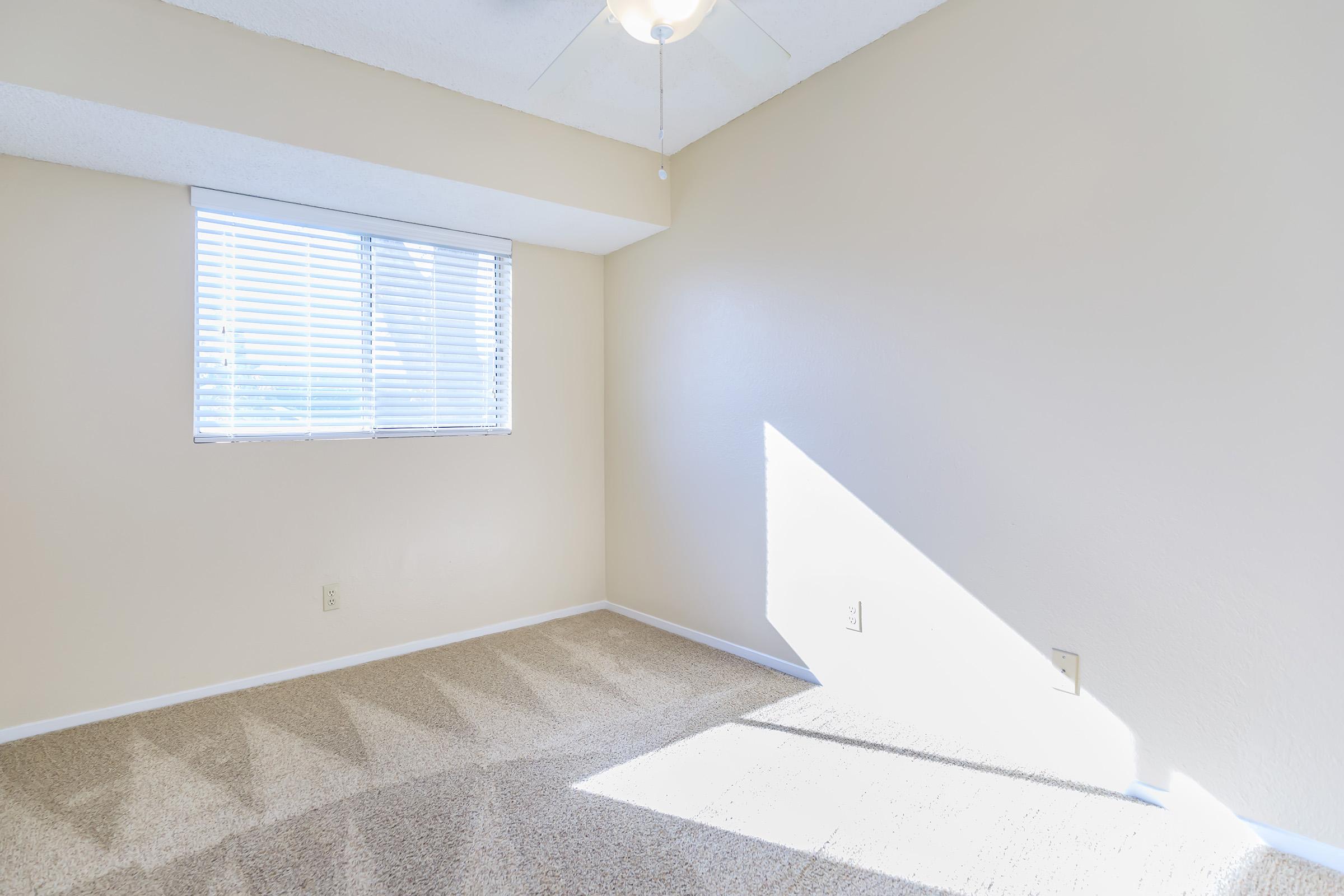 a bedroom with a large window