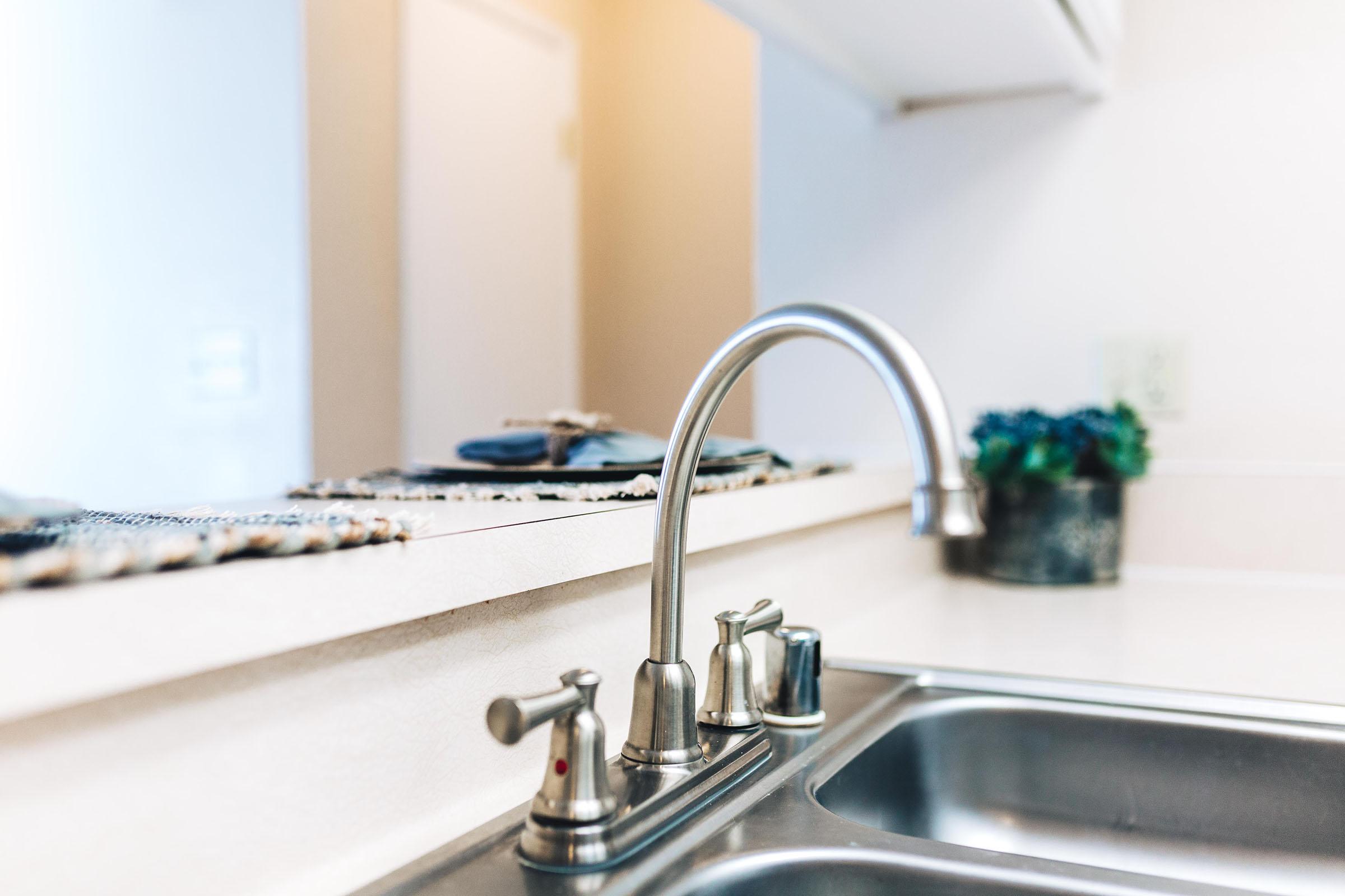 a kitchen with a sink and a mirror