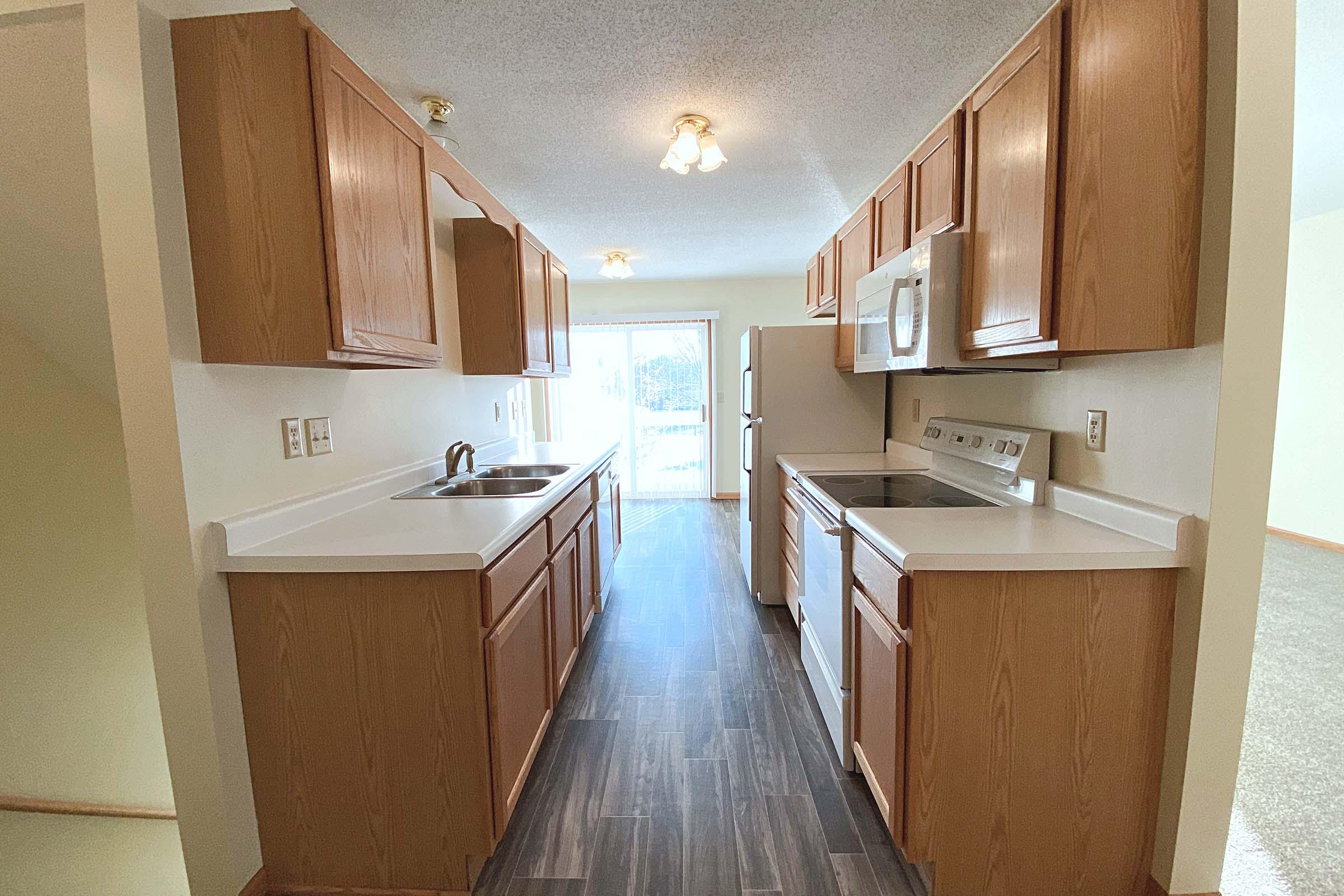 a kitchen with a sink and a refrigerator