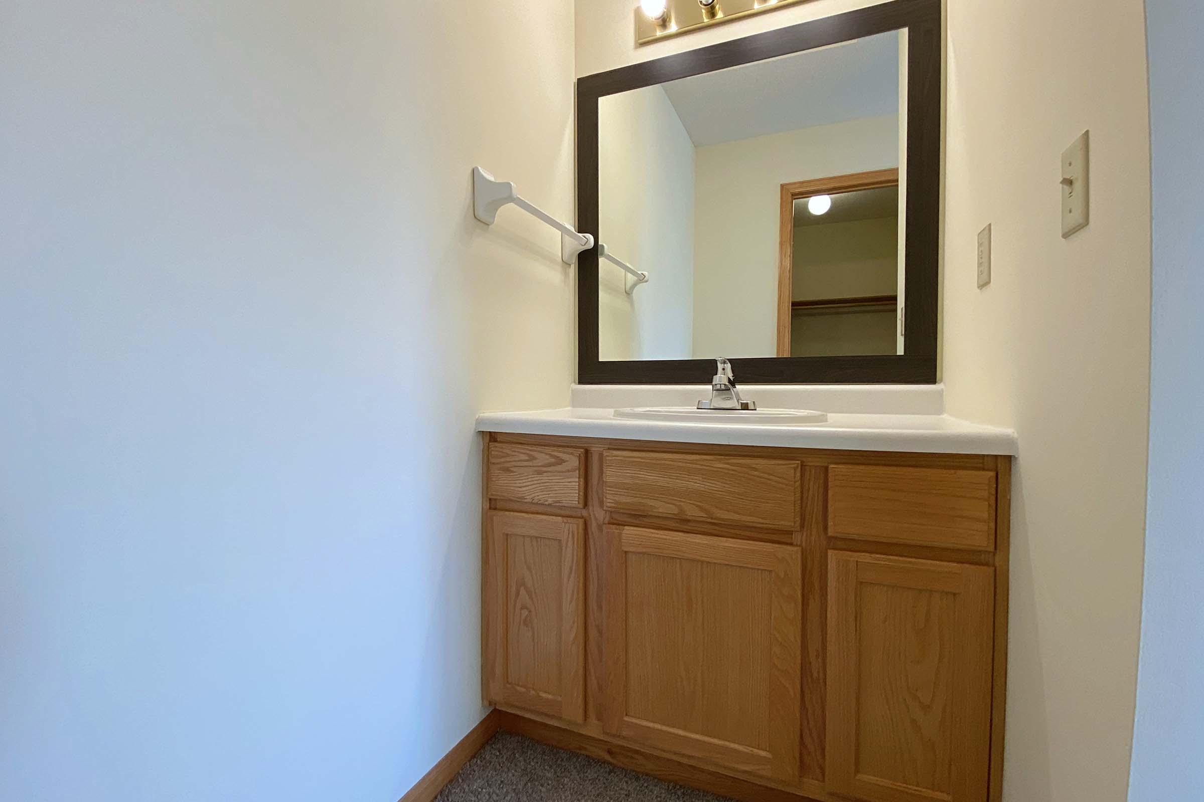 a kitchen with a sink and a mirror