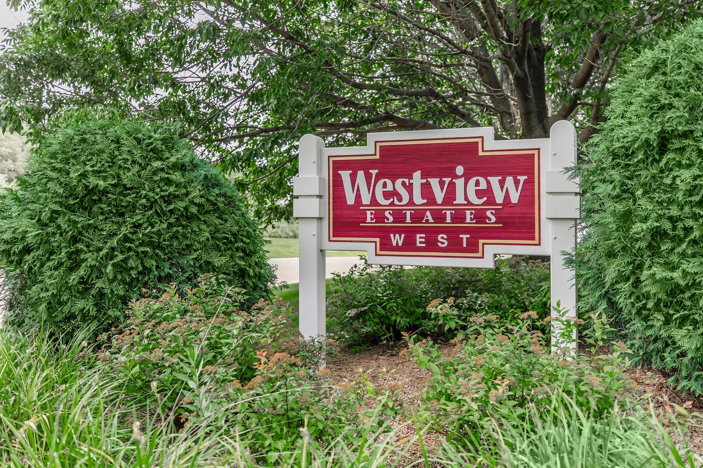 a sign in front of a tree