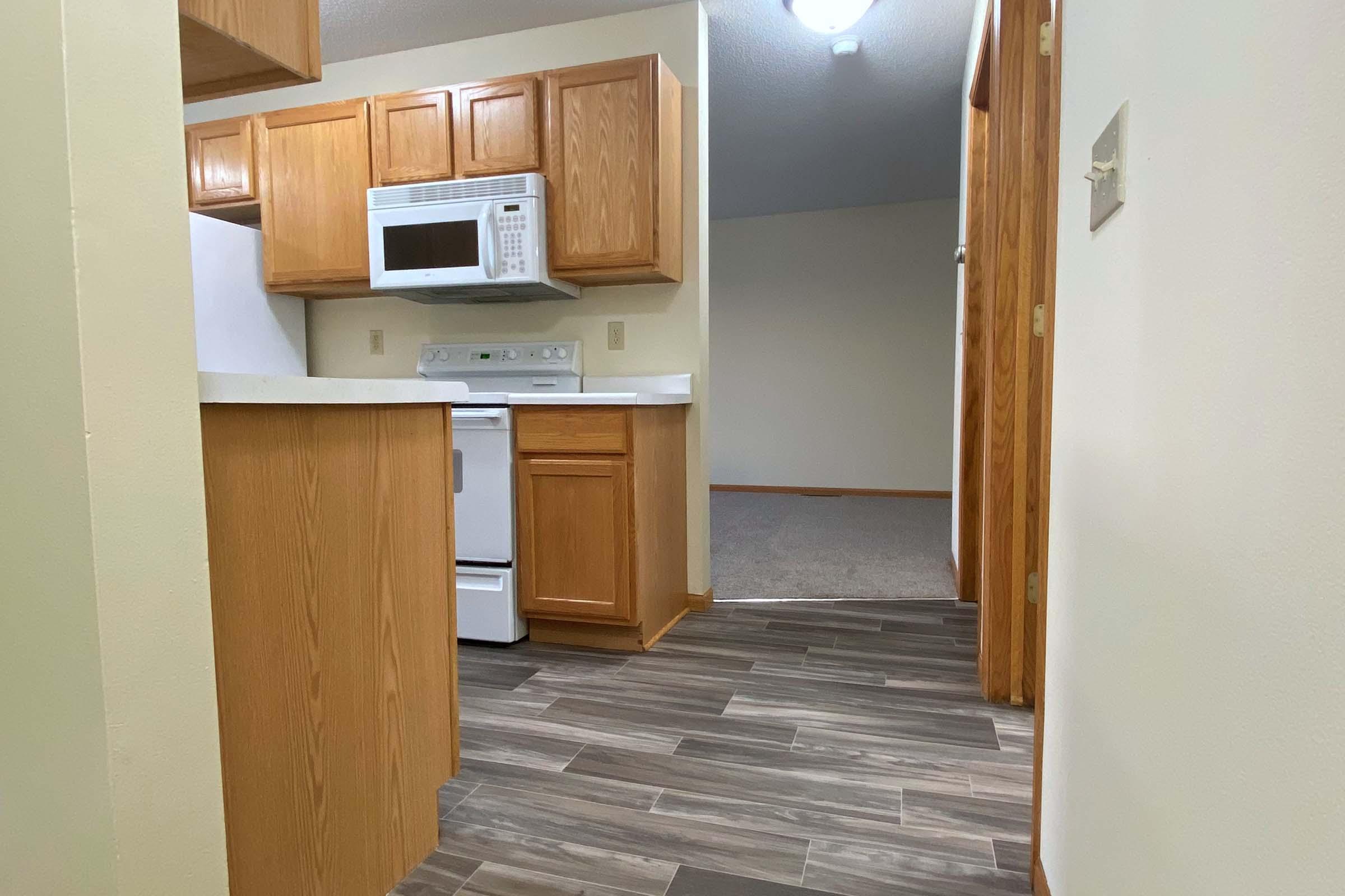 a kitchen with wooden cabinets and a refrigerator