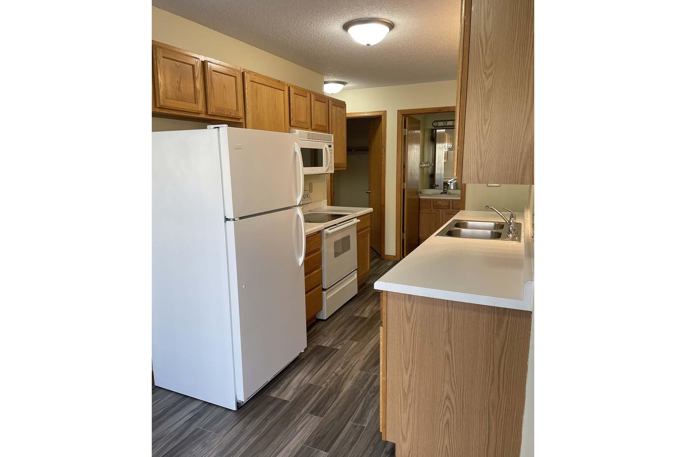 a kitchen with a sink and a refrigerator