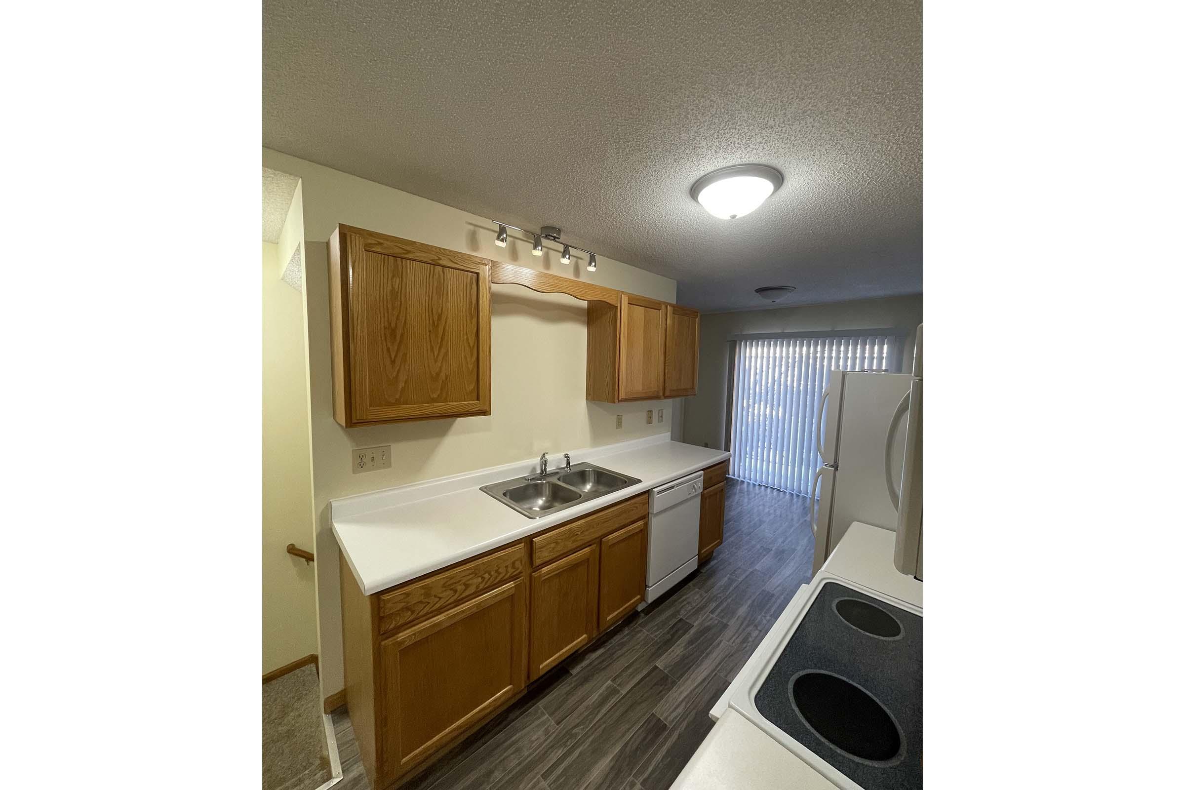 a kitchen with a sink and a mirror