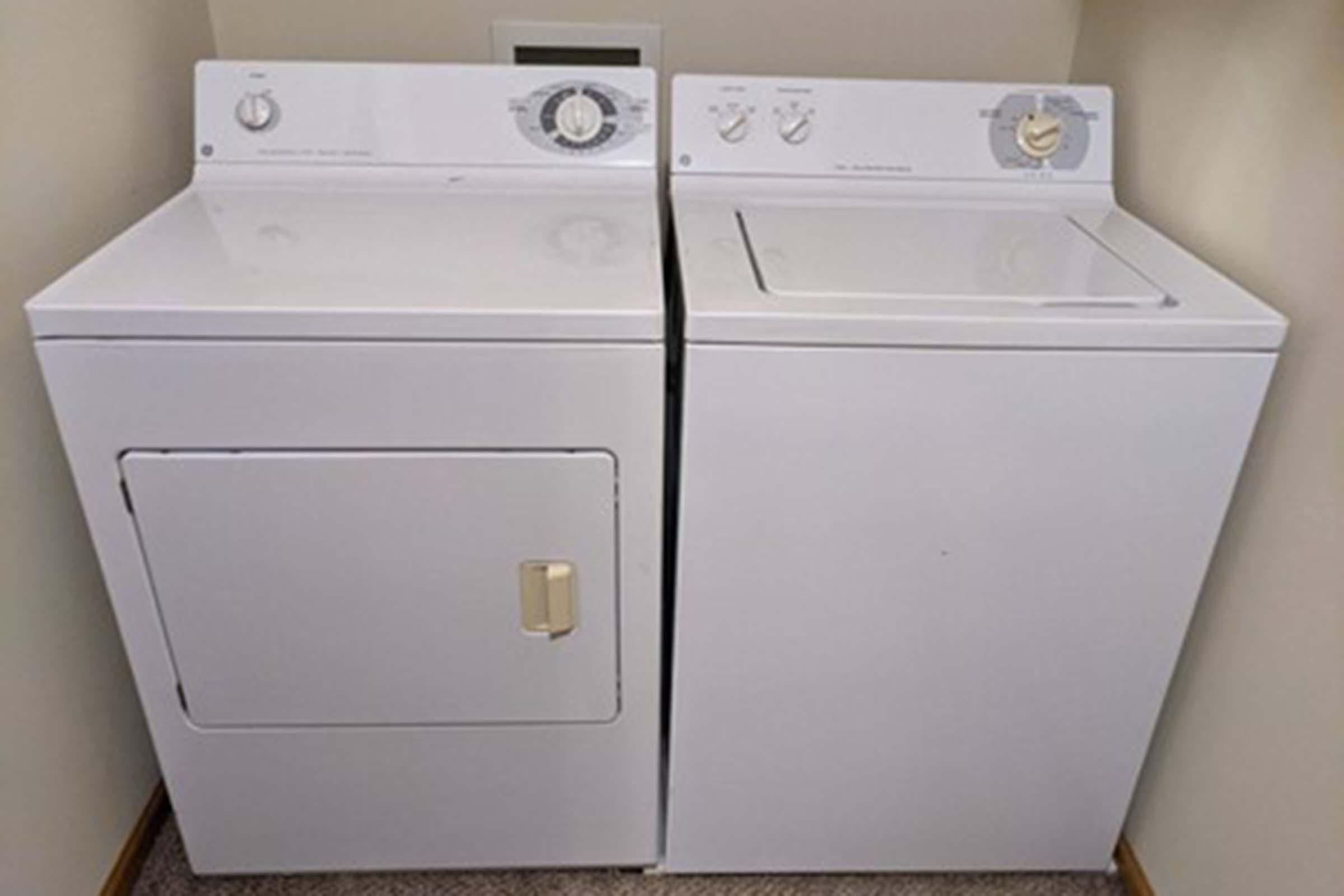 a microwave oven sitting on top of a refrigerator