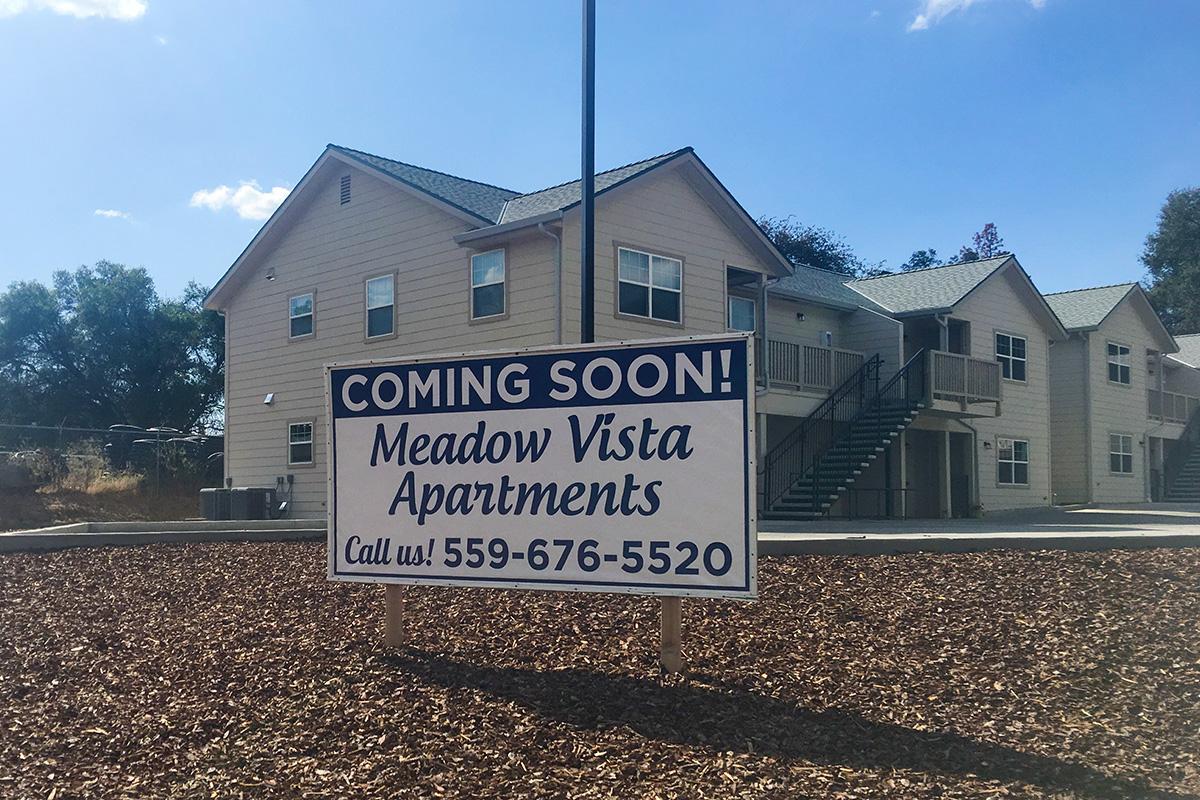 a house that has a sign on the side of a building