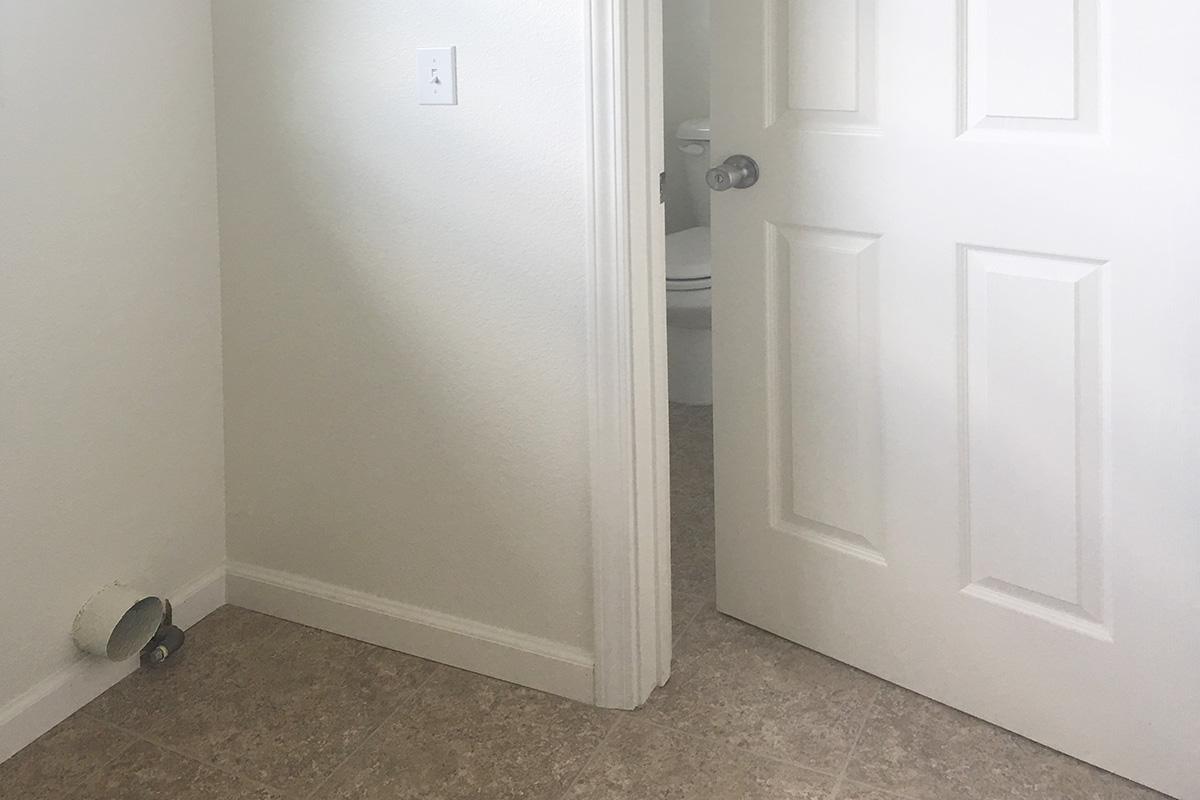 a white sink sitting next to a door