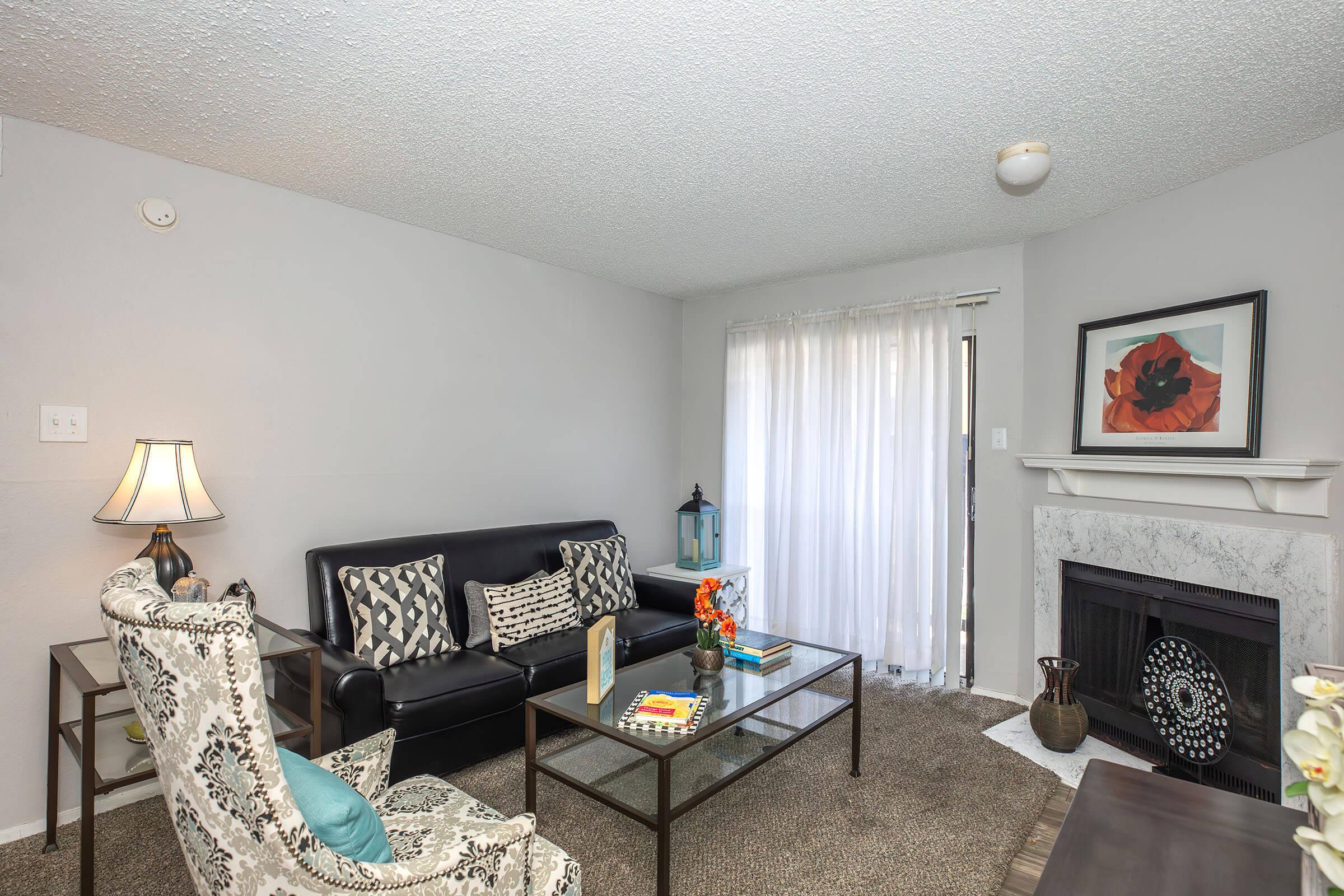 a living room filled with furniture and a fire place