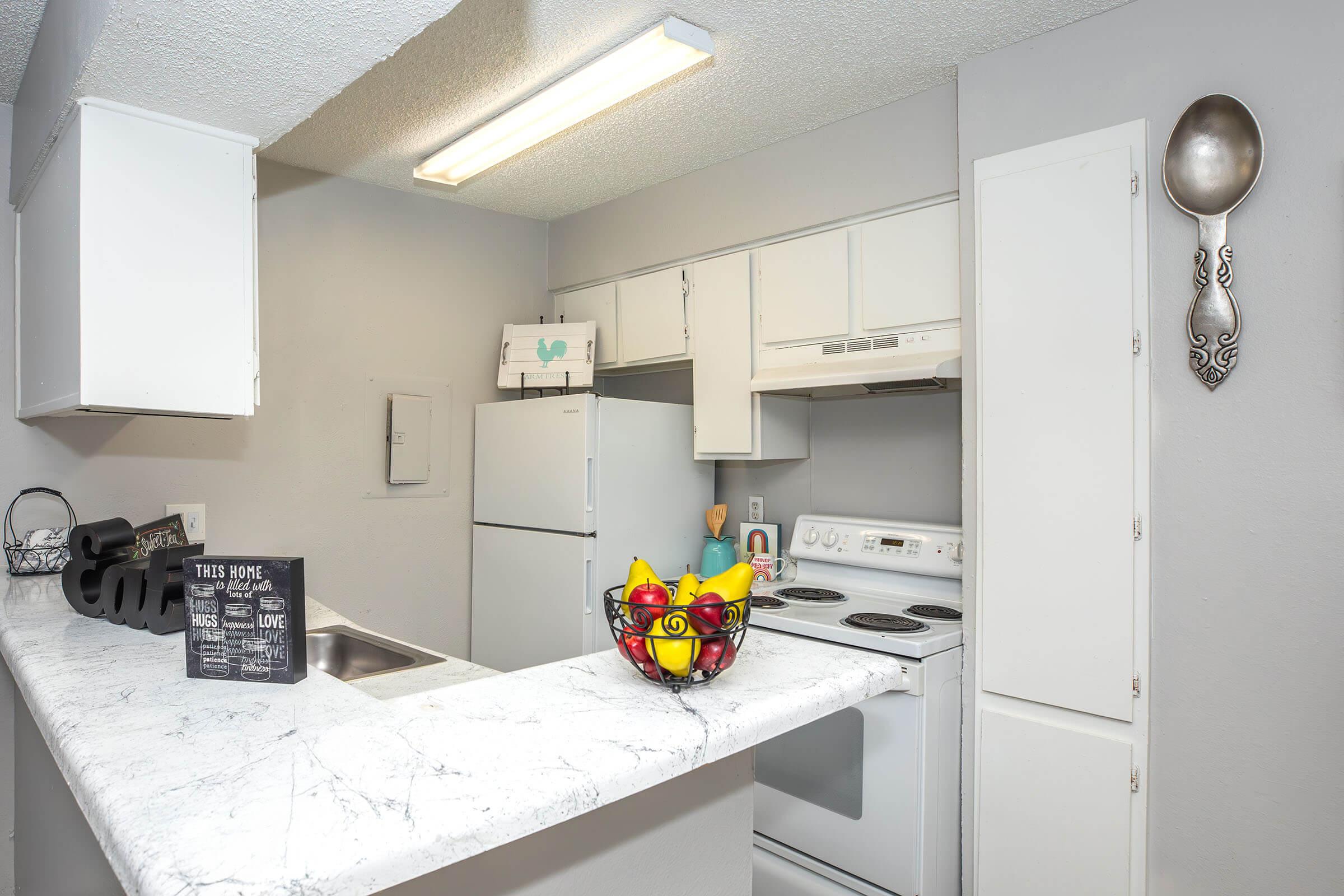 a kitchen with a stove and a refrigerator