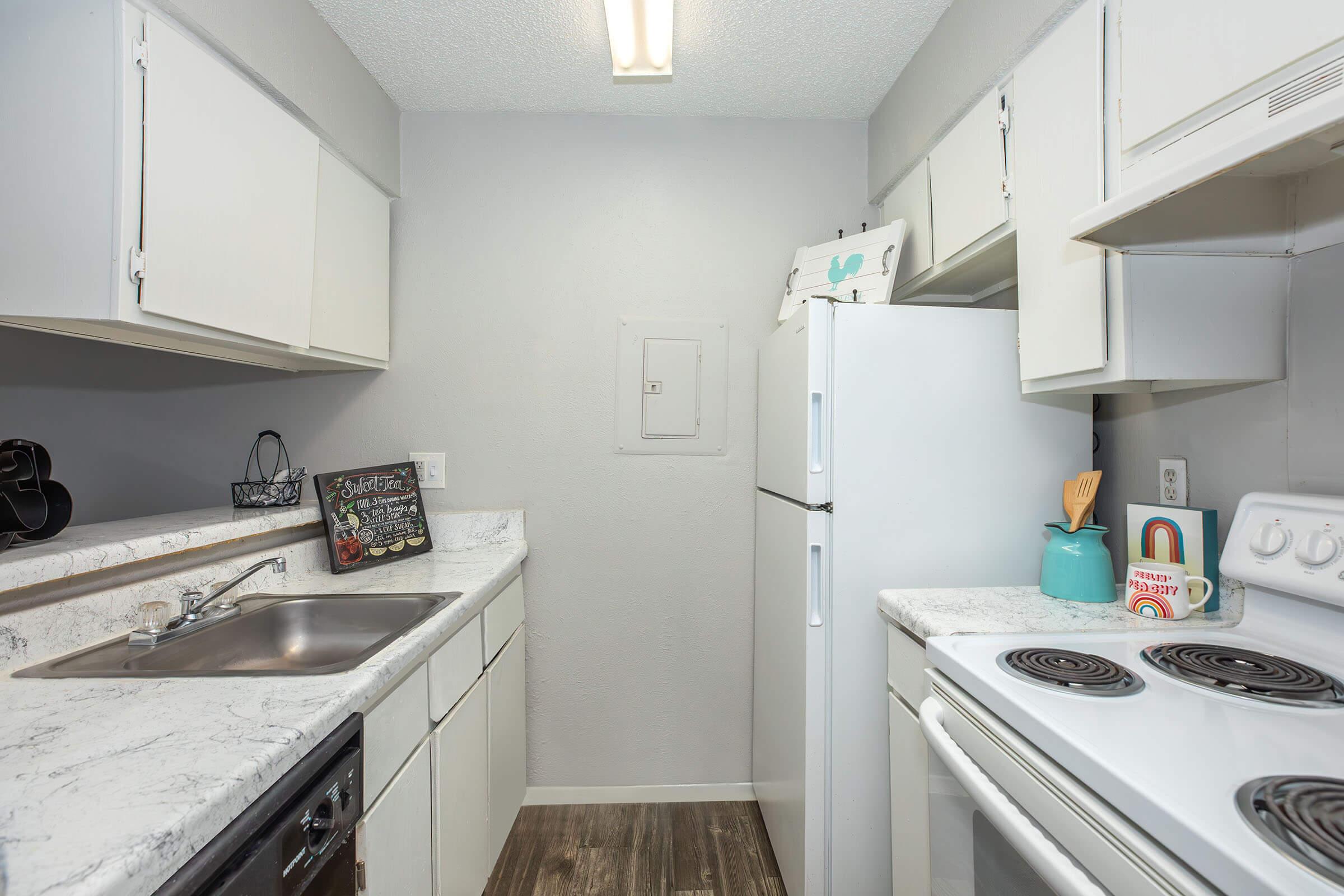 a kitchen with a stove sink and refrigerator