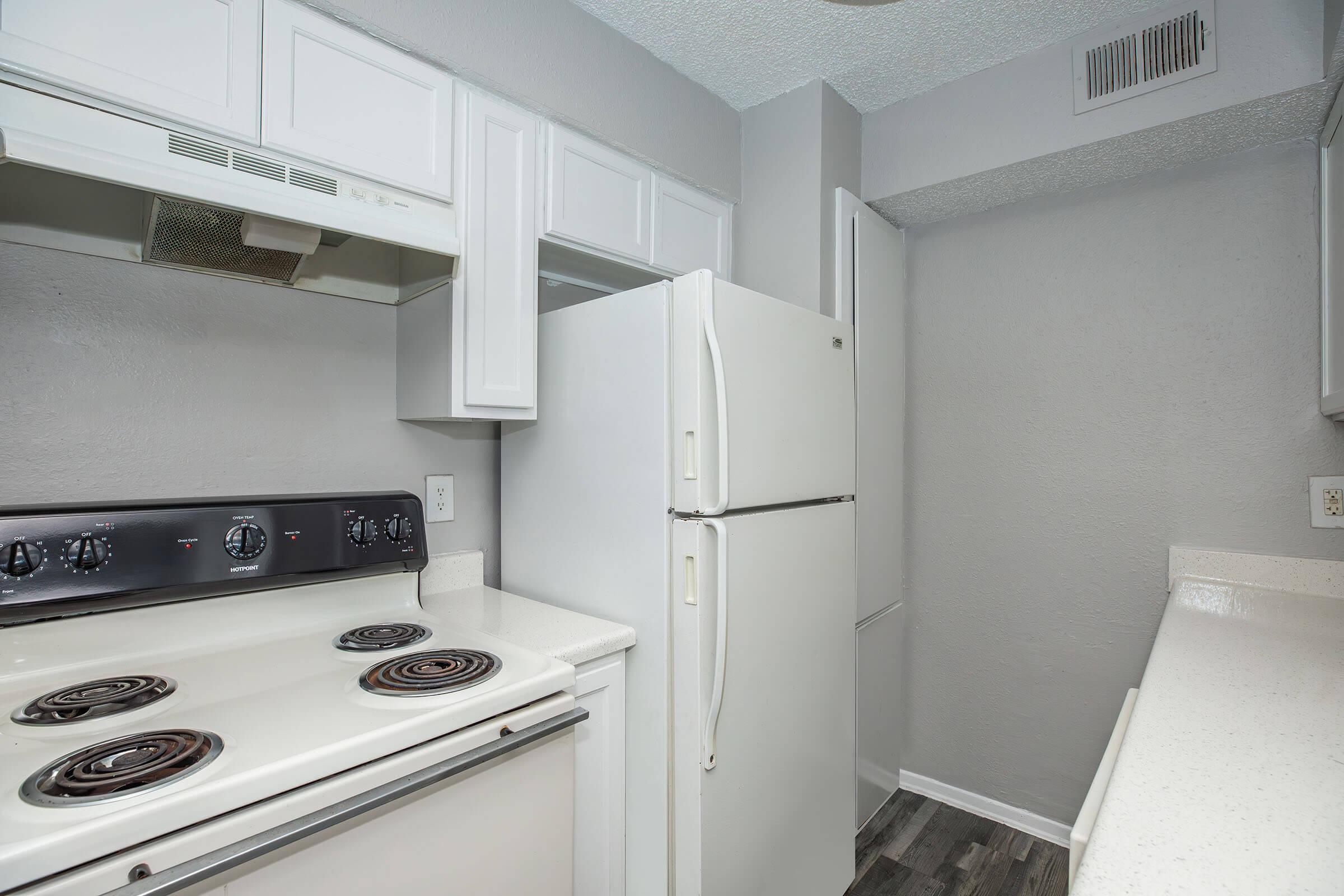 a stove top oven sitting inside of a kitchen