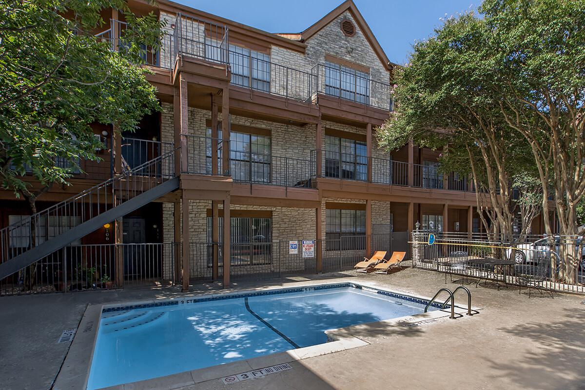 a house with a pool outside of a building