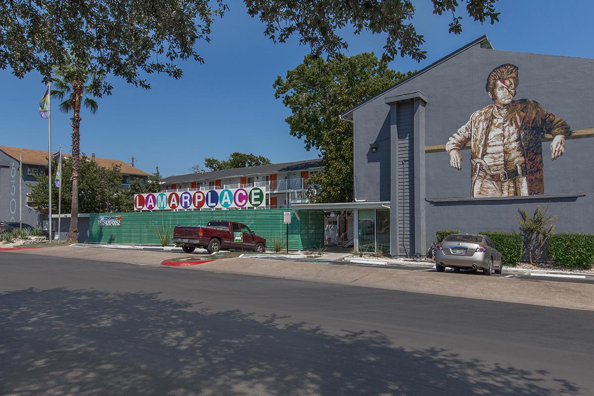 a building with a clock on the side of a road