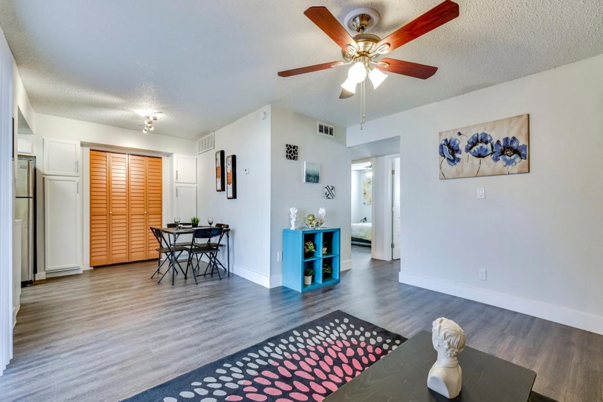 a living room filled with furniture and a wood floor