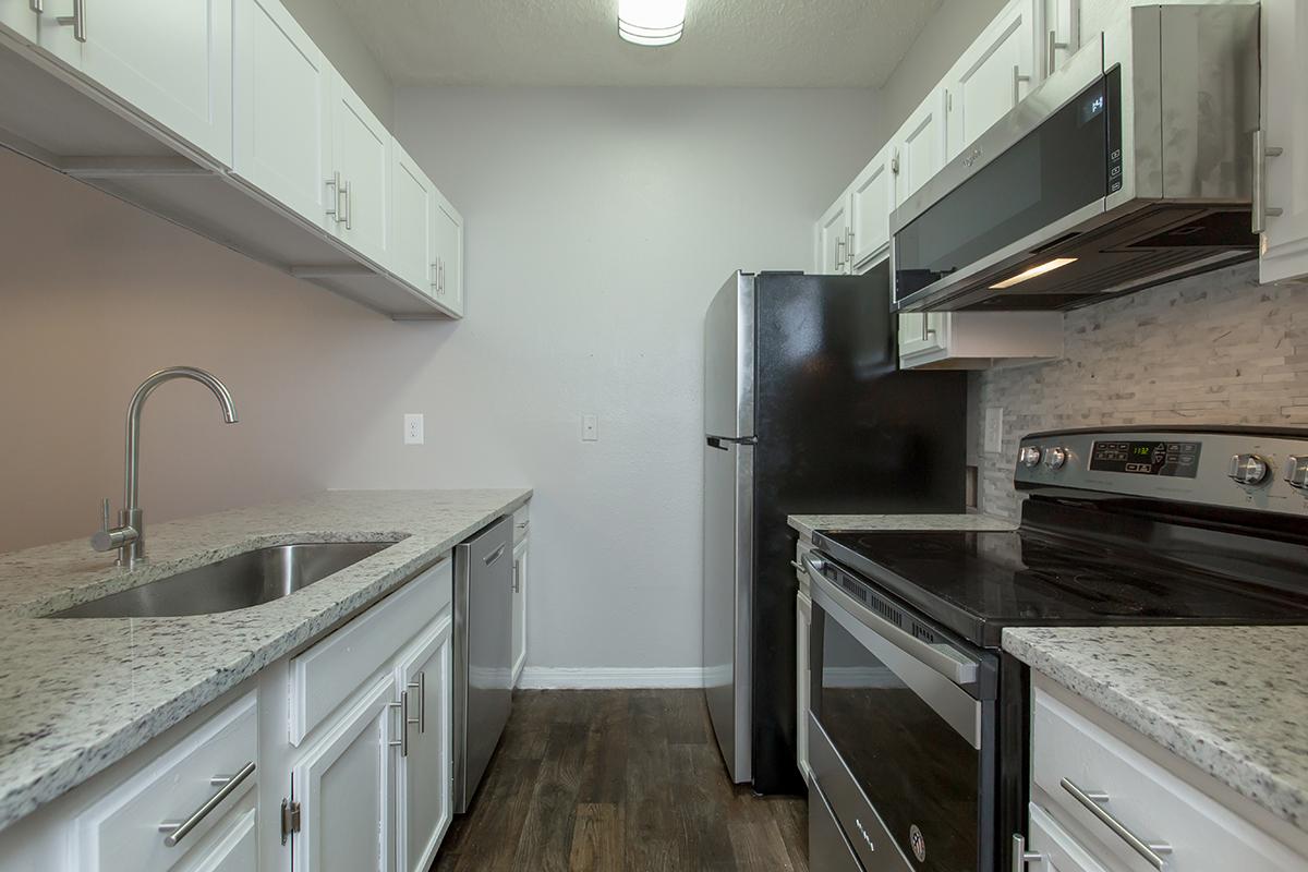 a large kitchen with stainless steel appliances