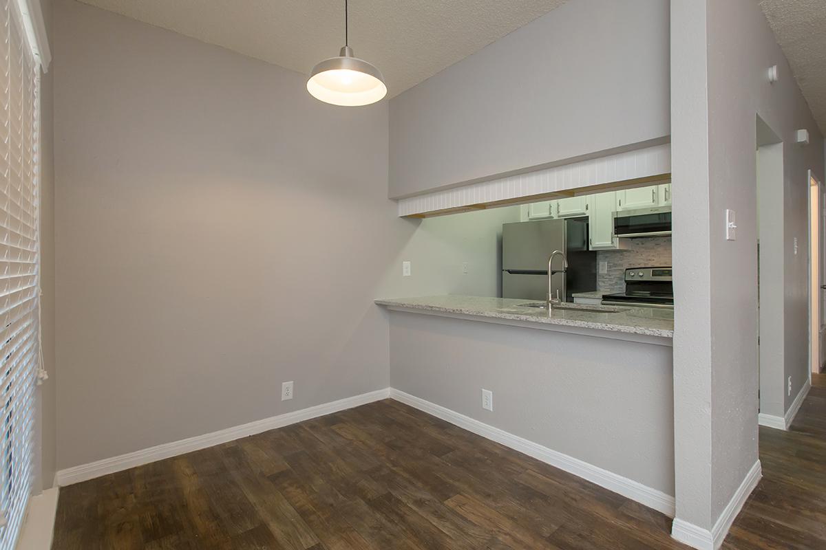 a large empty room with a sink and a mirror