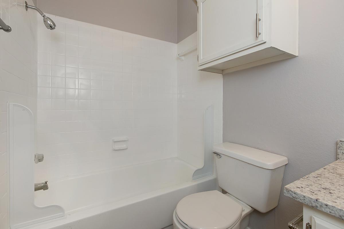 a white tub sitting next to a sink