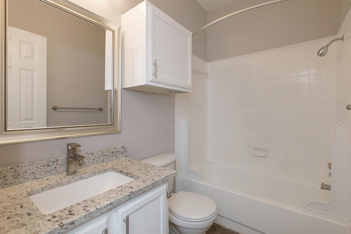 a large white tub next to a sink