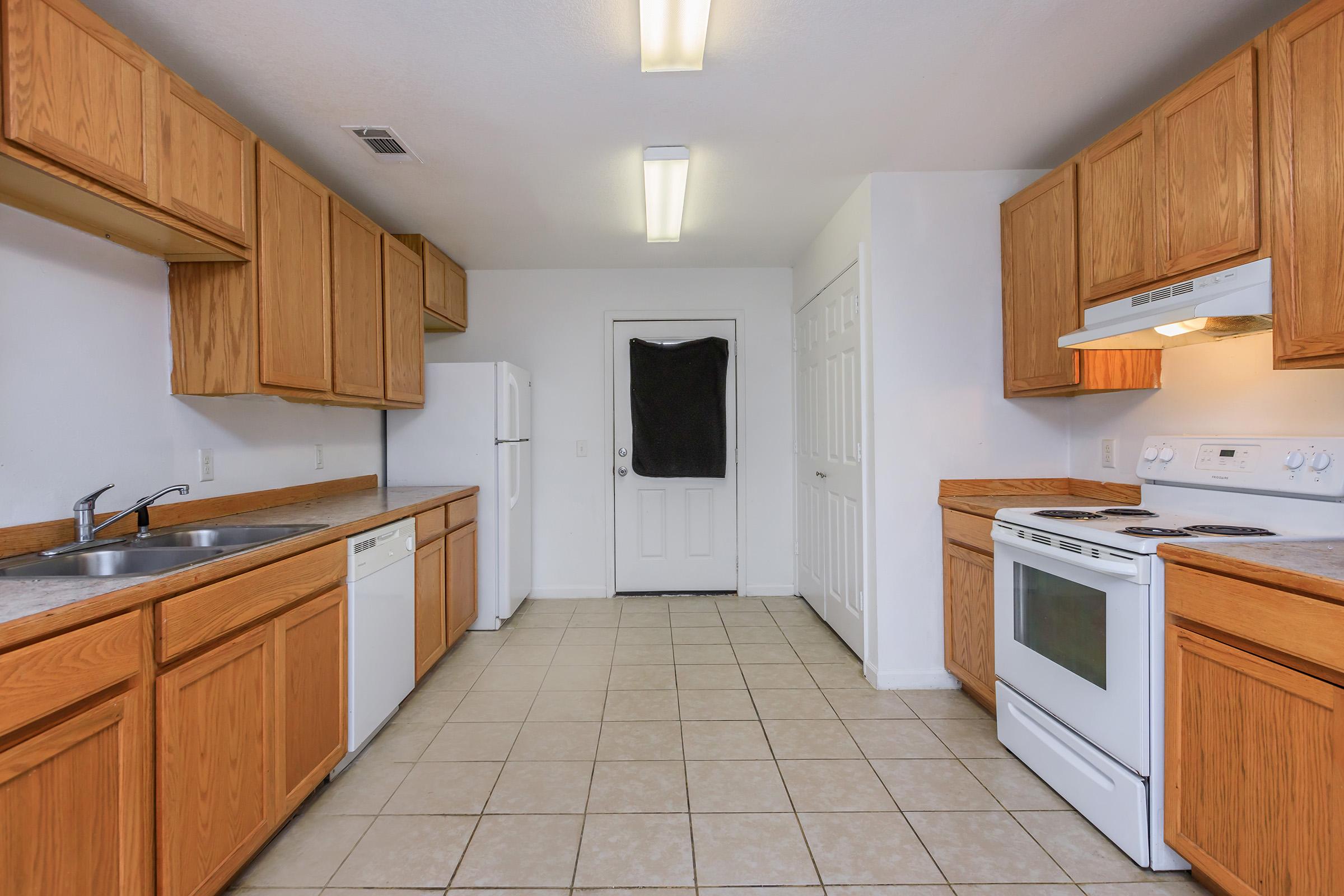 a kitchen with a stove and a refrigerator