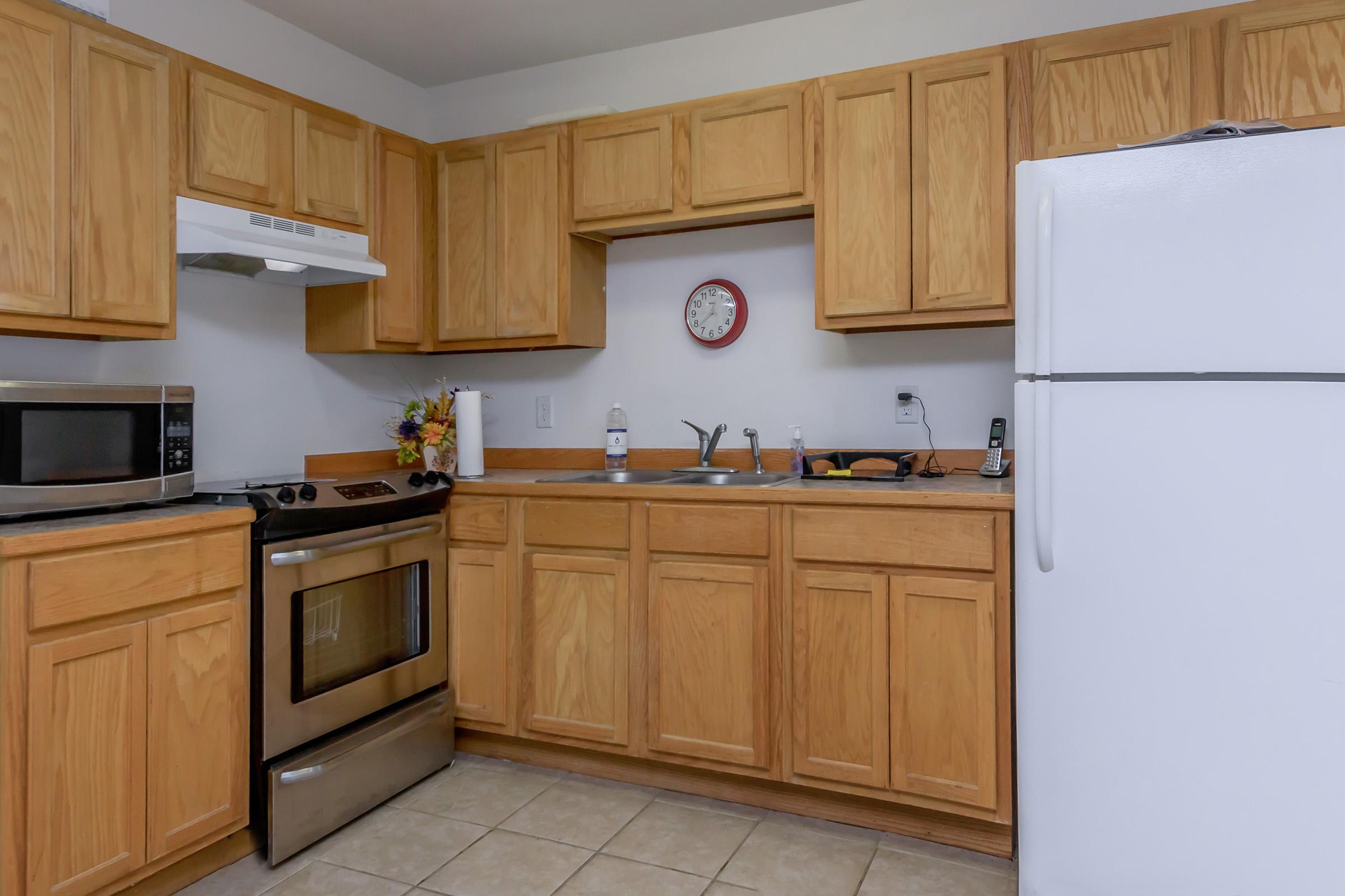 a kitchen with stainless steel appliances and wooden cabinets