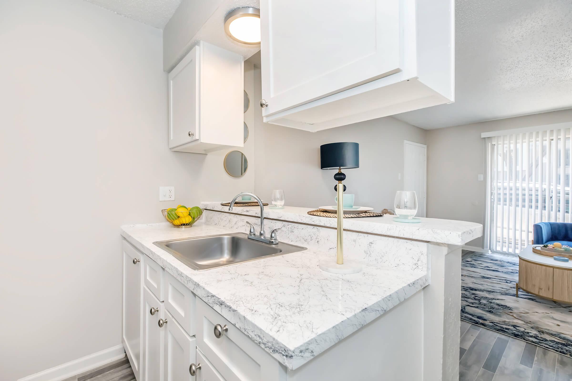 a kitchen with a sink and a mirror