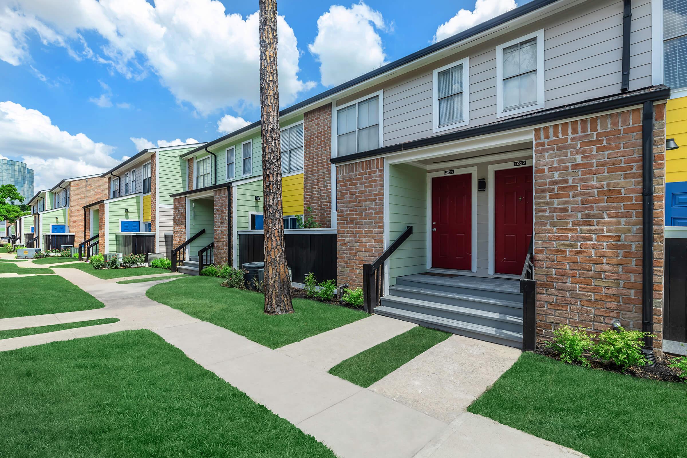 a large lawn in front of a brick building