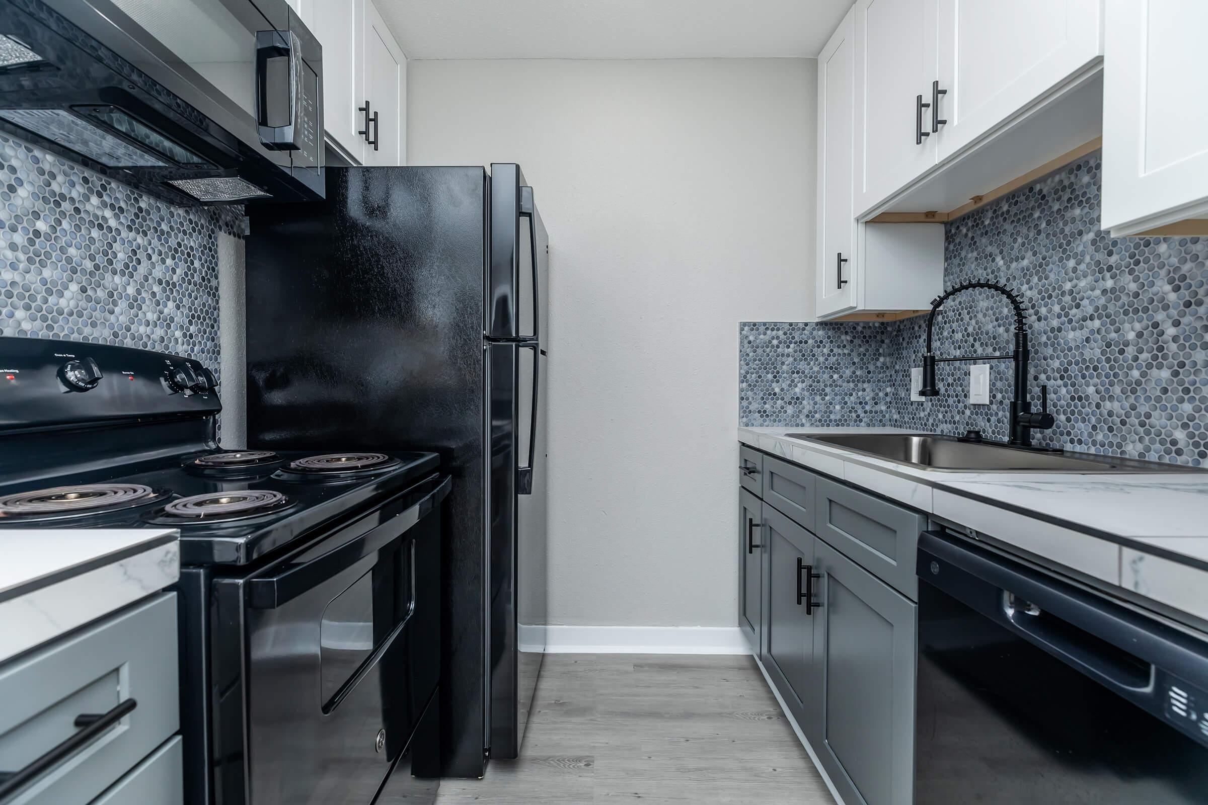 a stove top oven sitting inside of a kitchen