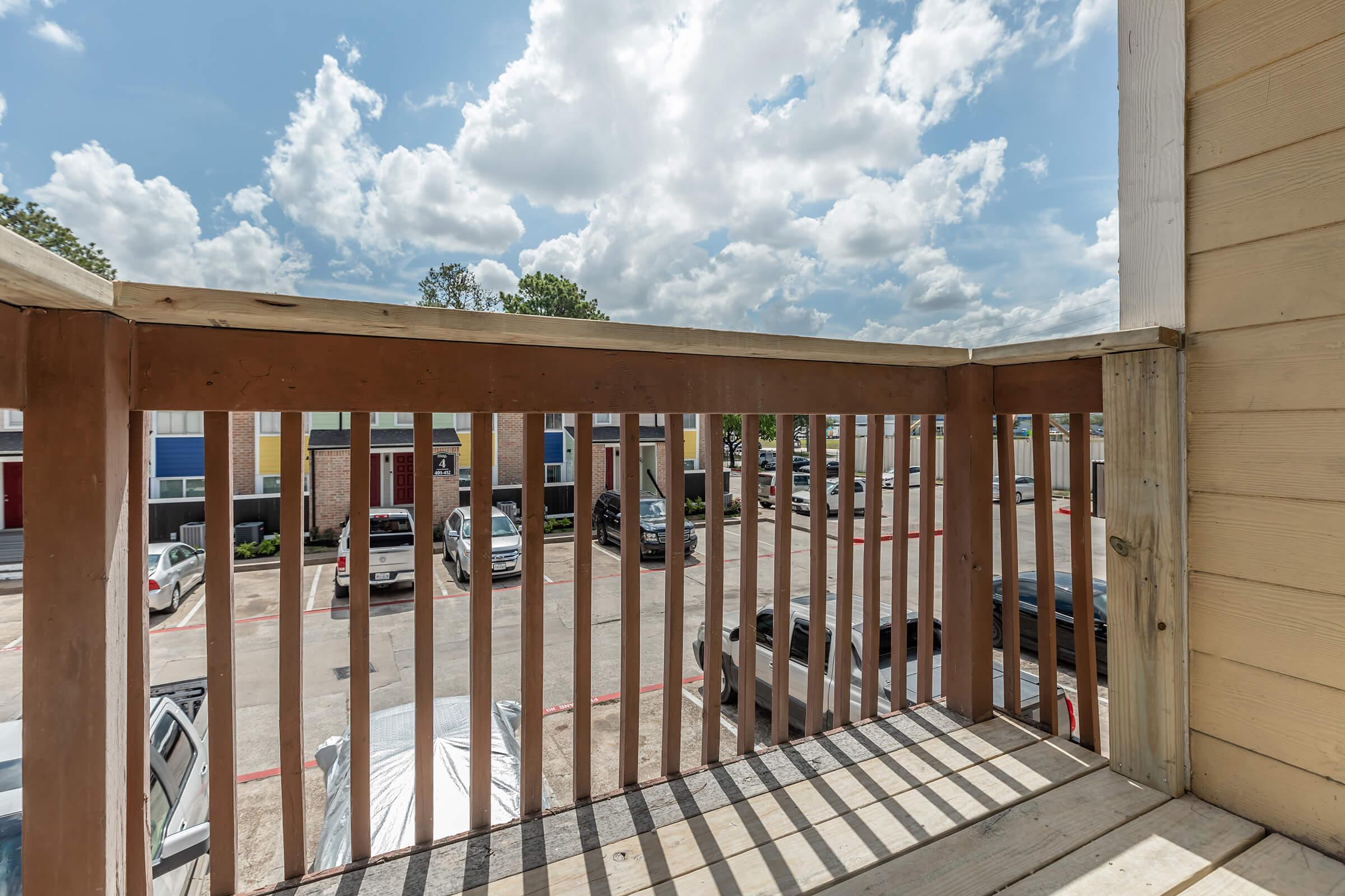 a wooden bench sitting in front of a building