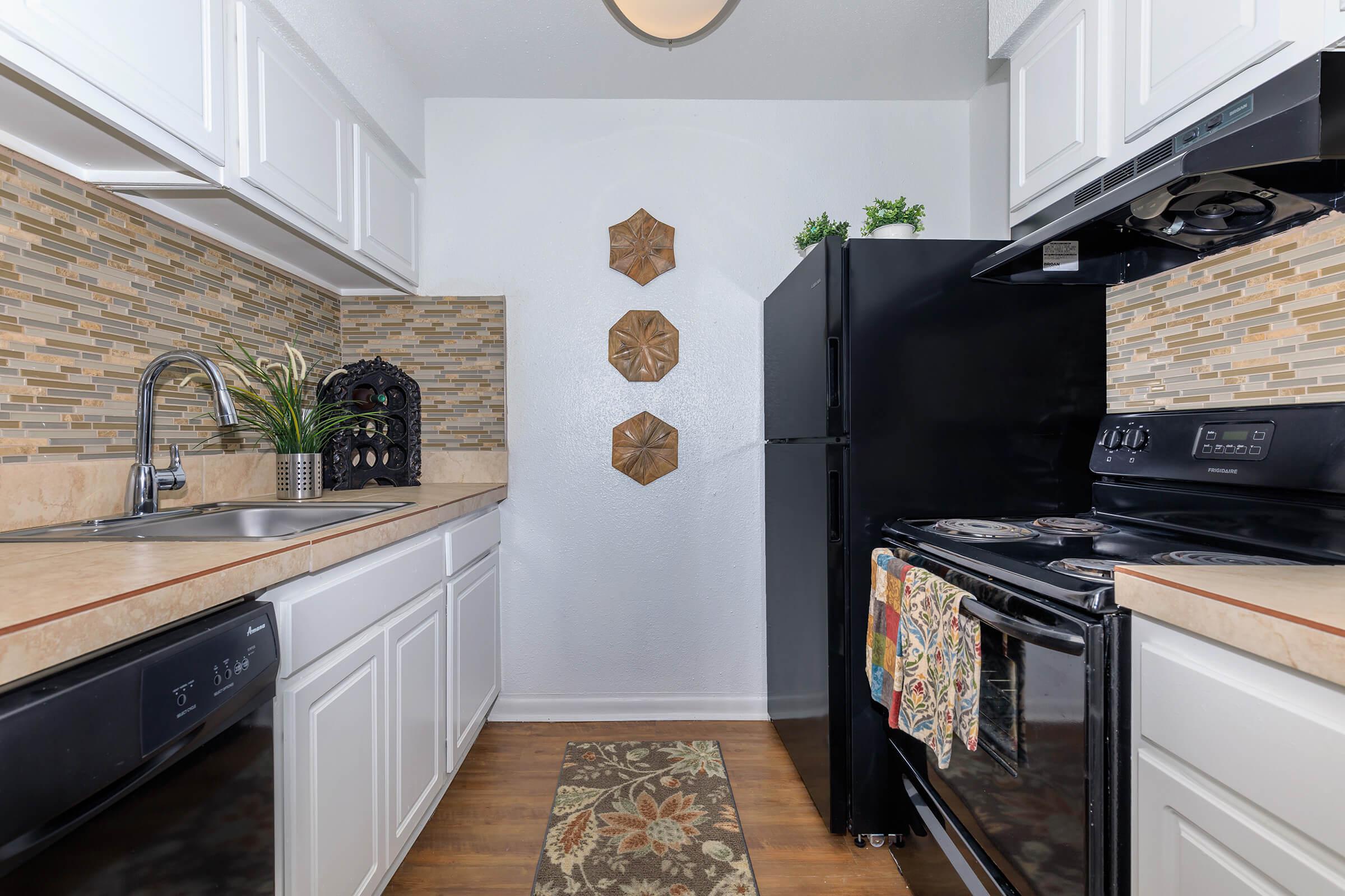 a stove top oven sitting inside of a kitchen