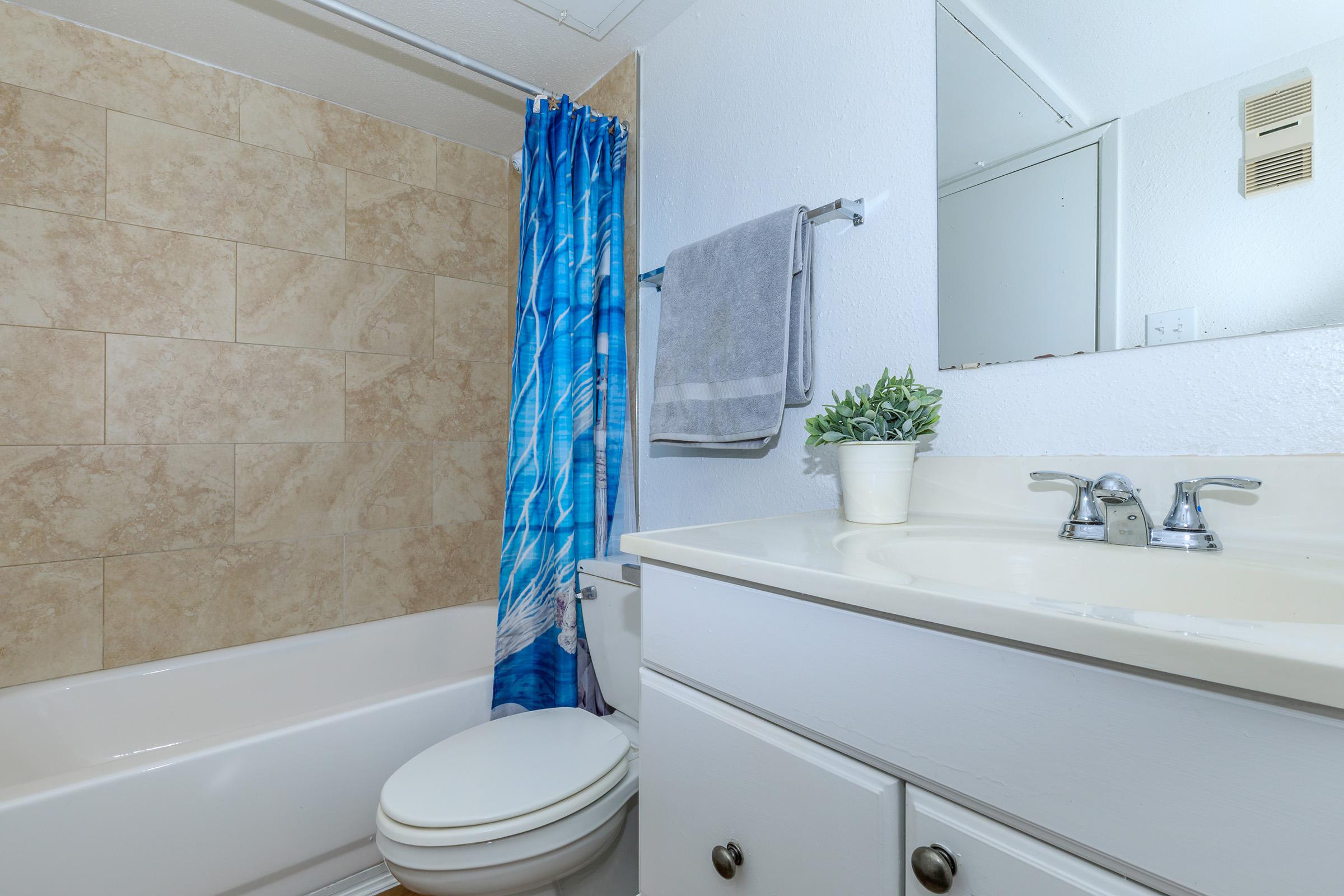 a white tub sitting next to a shower