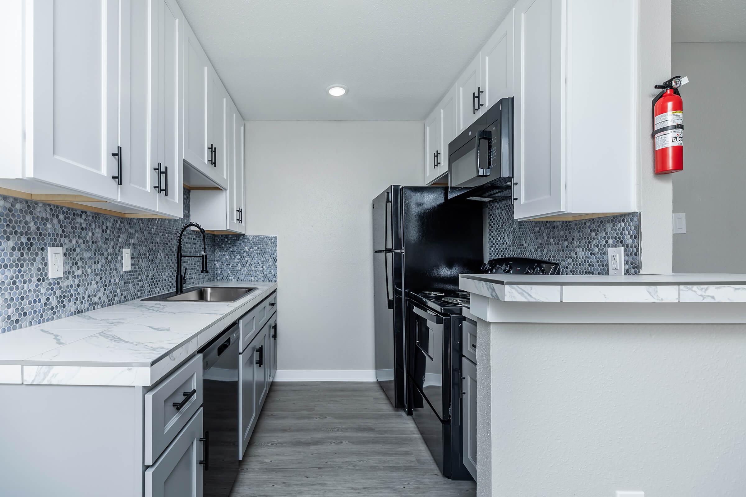 a kitchen with a stove sink and refrigerator