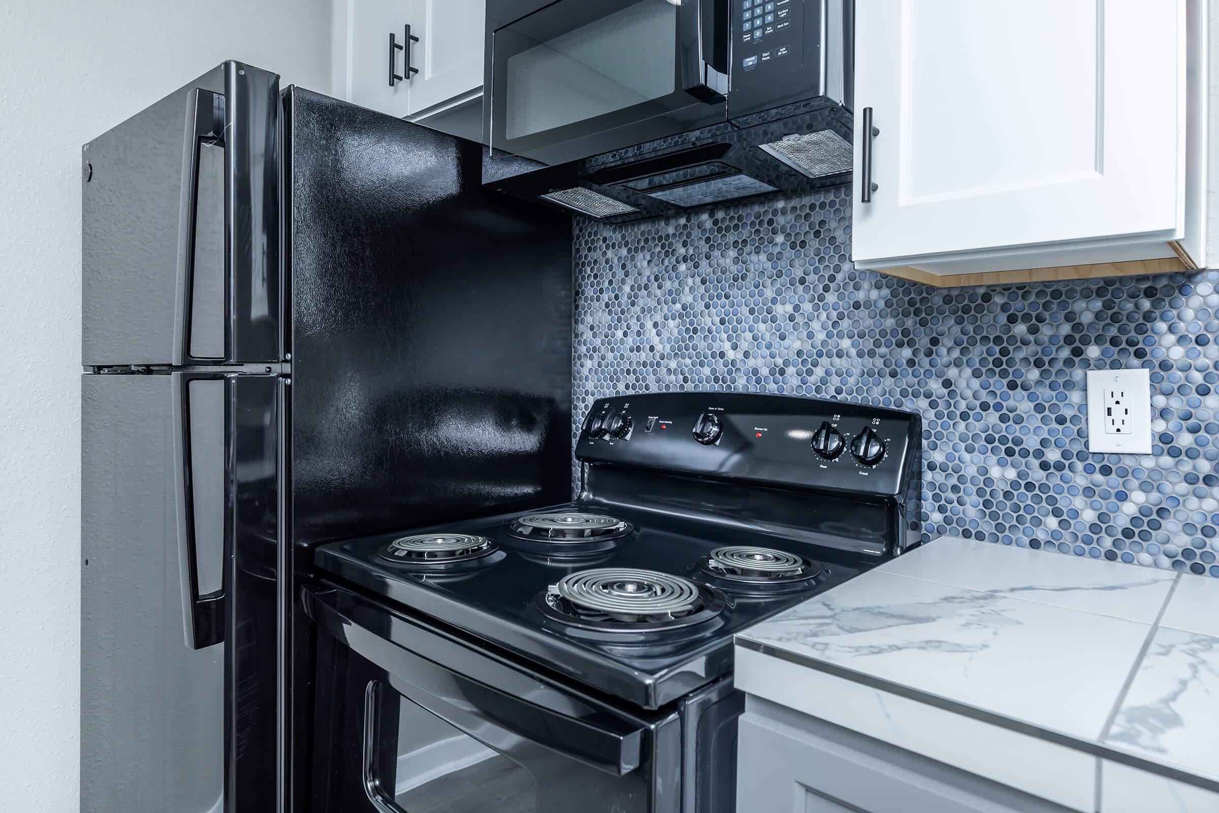 a stove top oven sitting inside of a kitchen