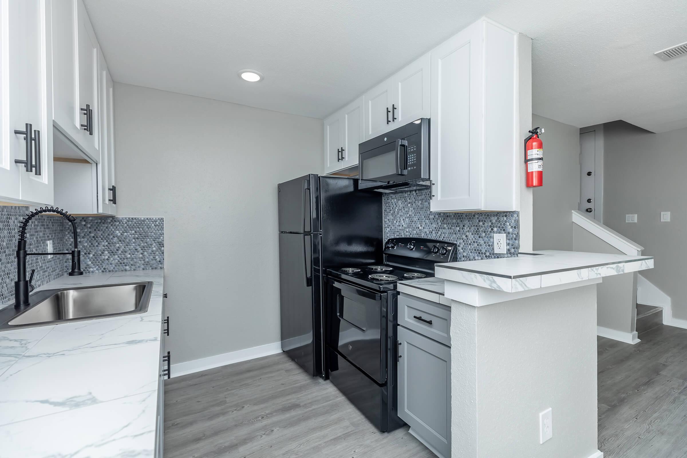 a kitchen with a sink and a refrigerator