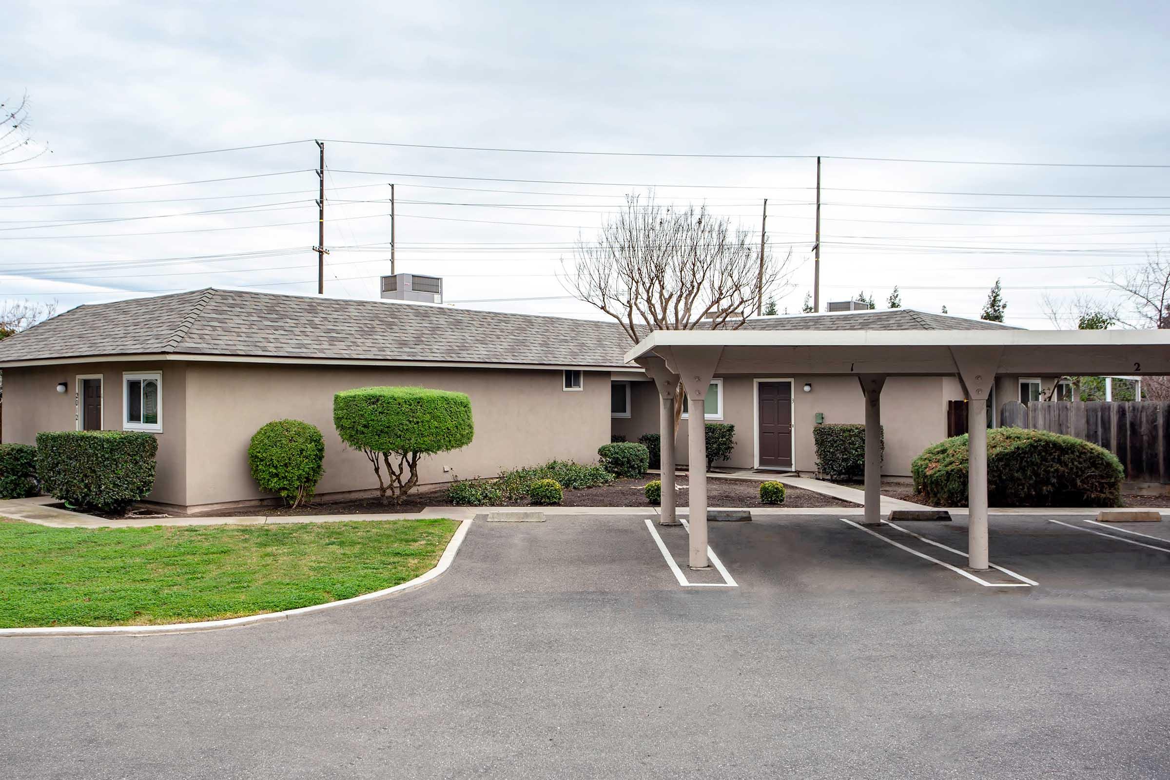 building exterior with covered parking