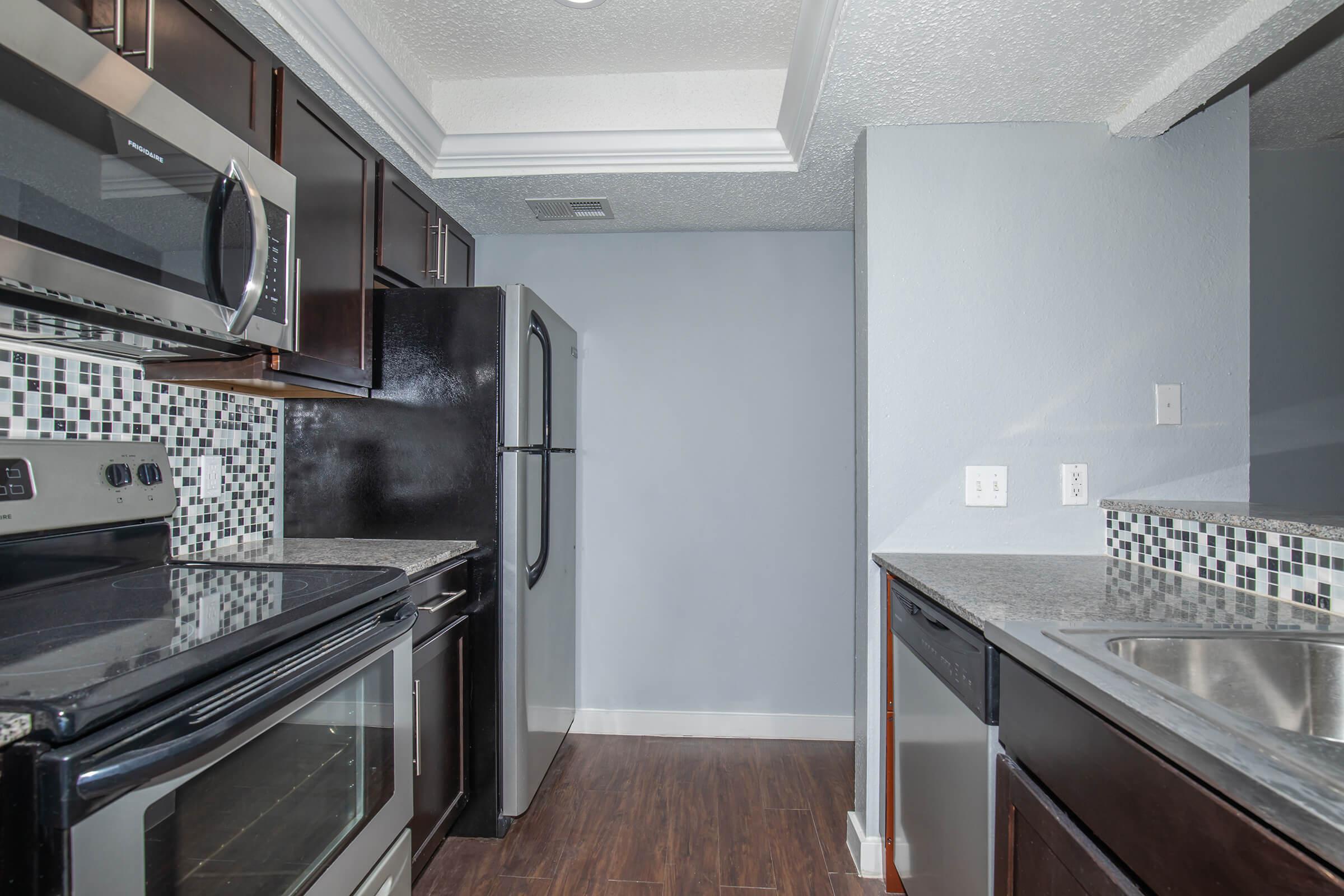 a large kitchen with stainless steel appliances