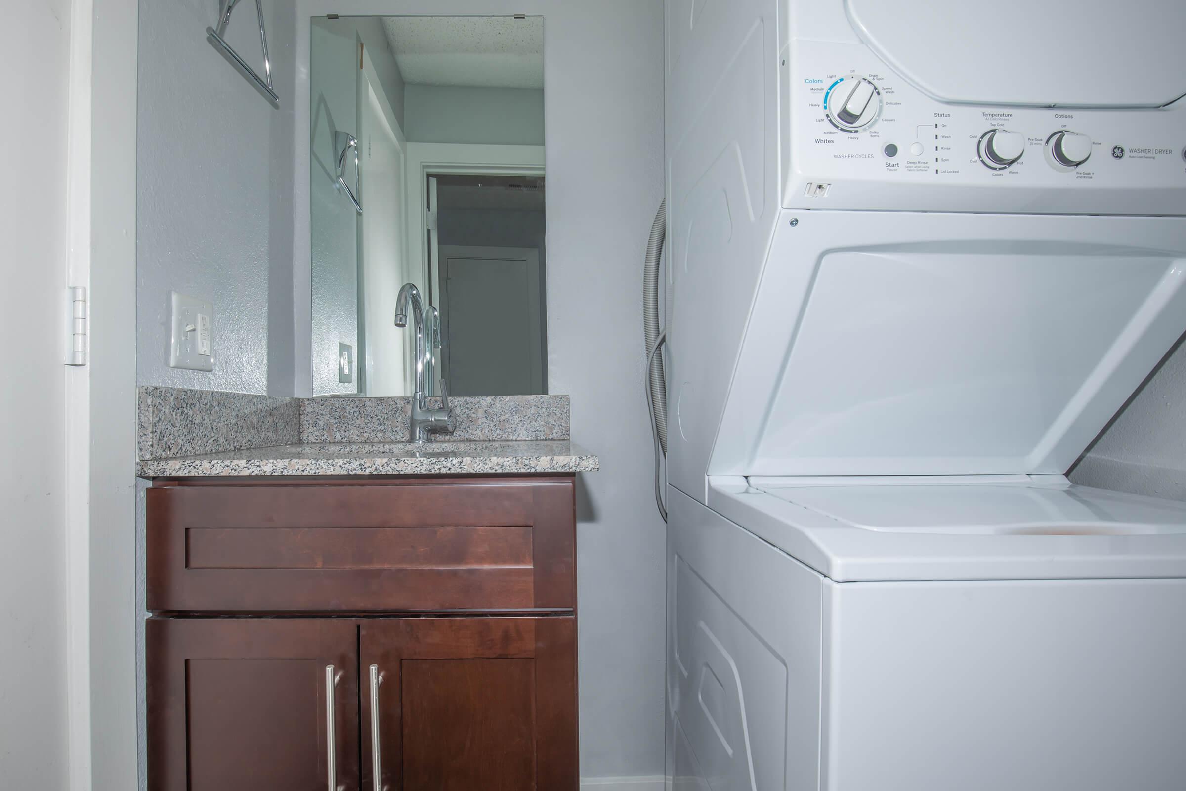 a white microwave oven sitting on top of a refrigerator