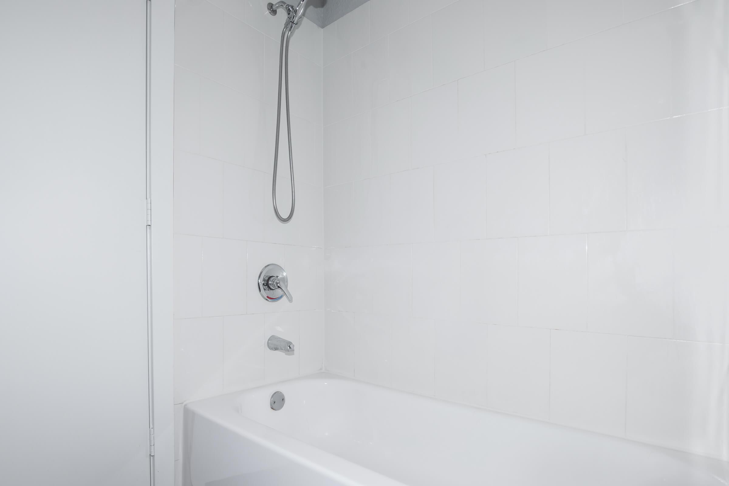 a white tub sitting next to a shower