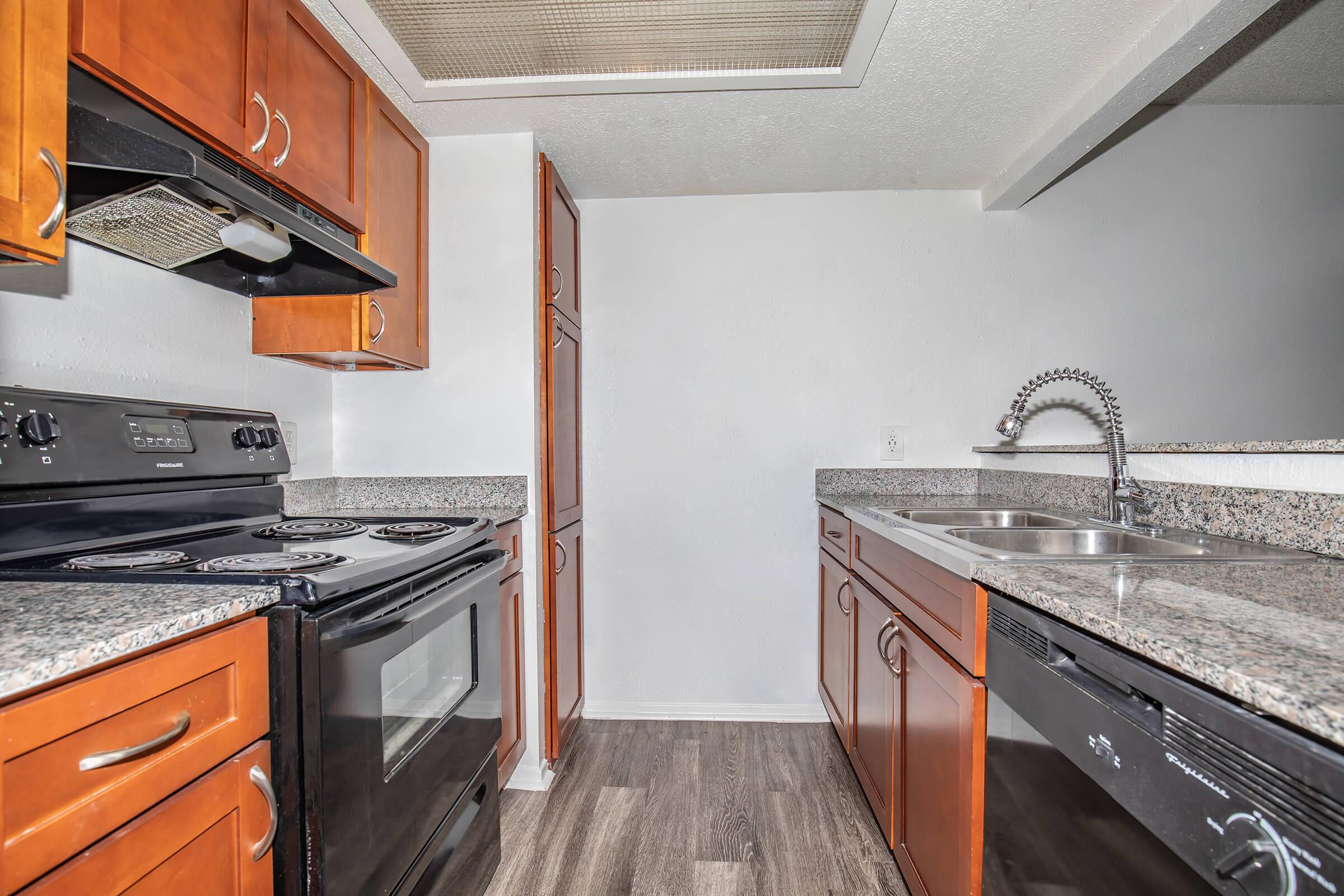 a kitchen with stainless steel appliances and wooden cabinets