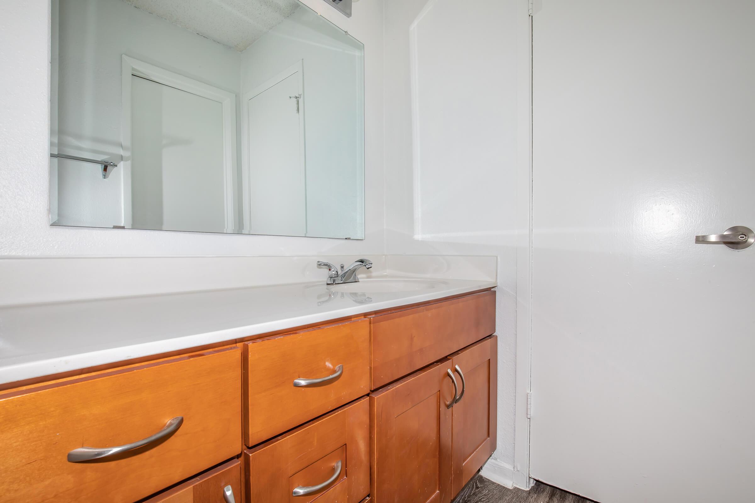 a kitchen with a sink and a mirror