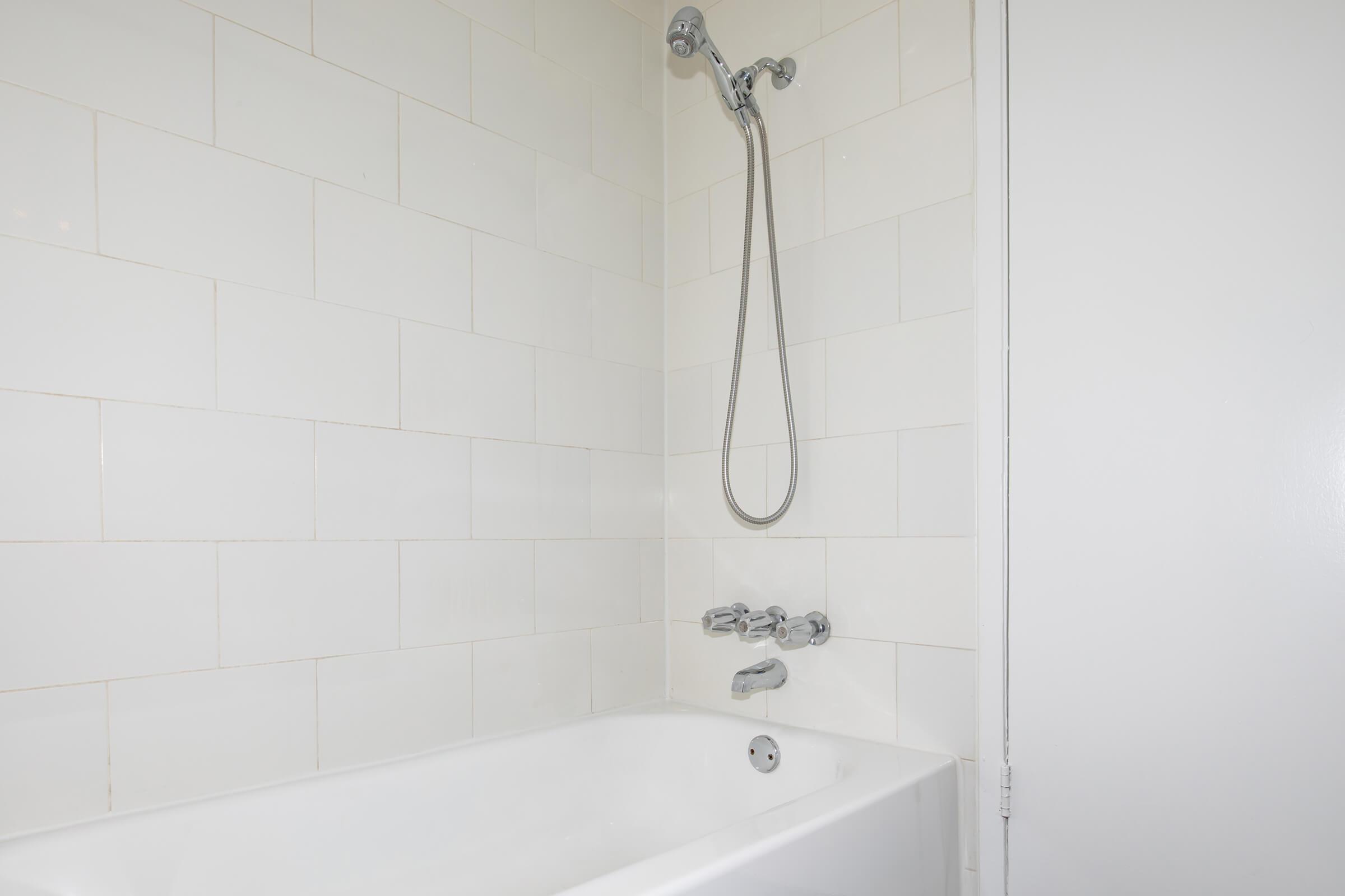 a white tub sitting next to a shower