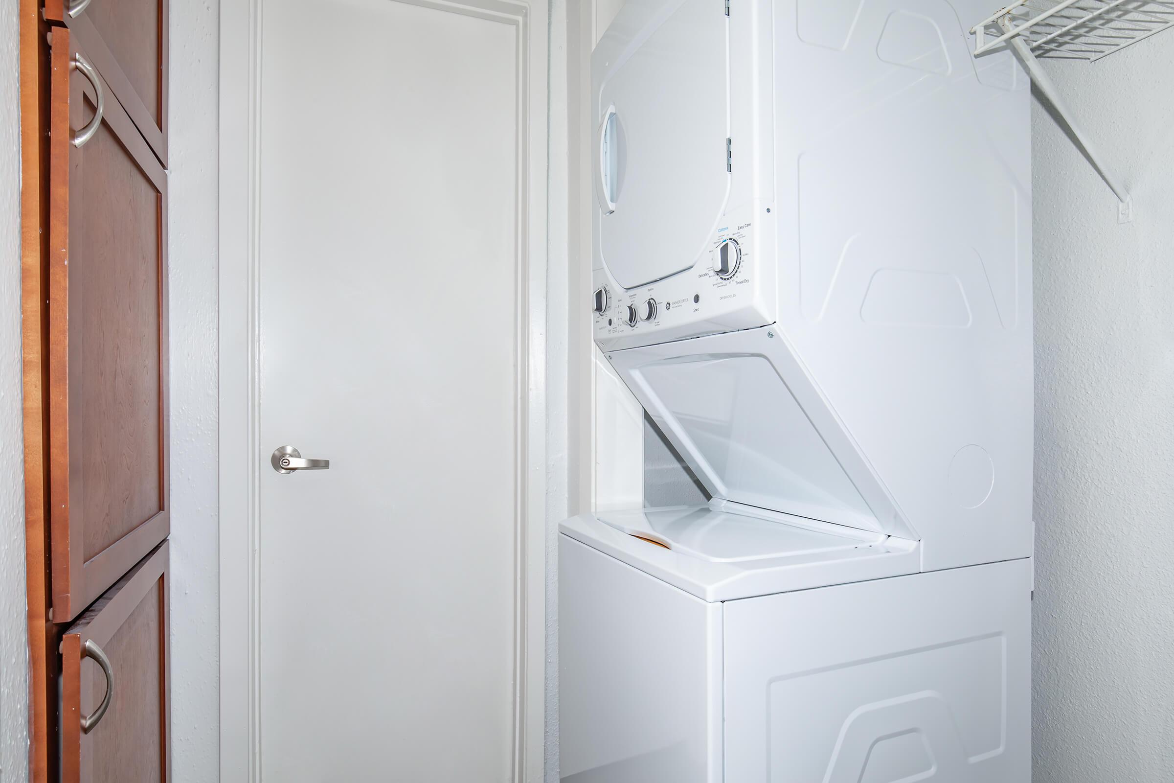 a white refrigerator freezer sitting next to a door